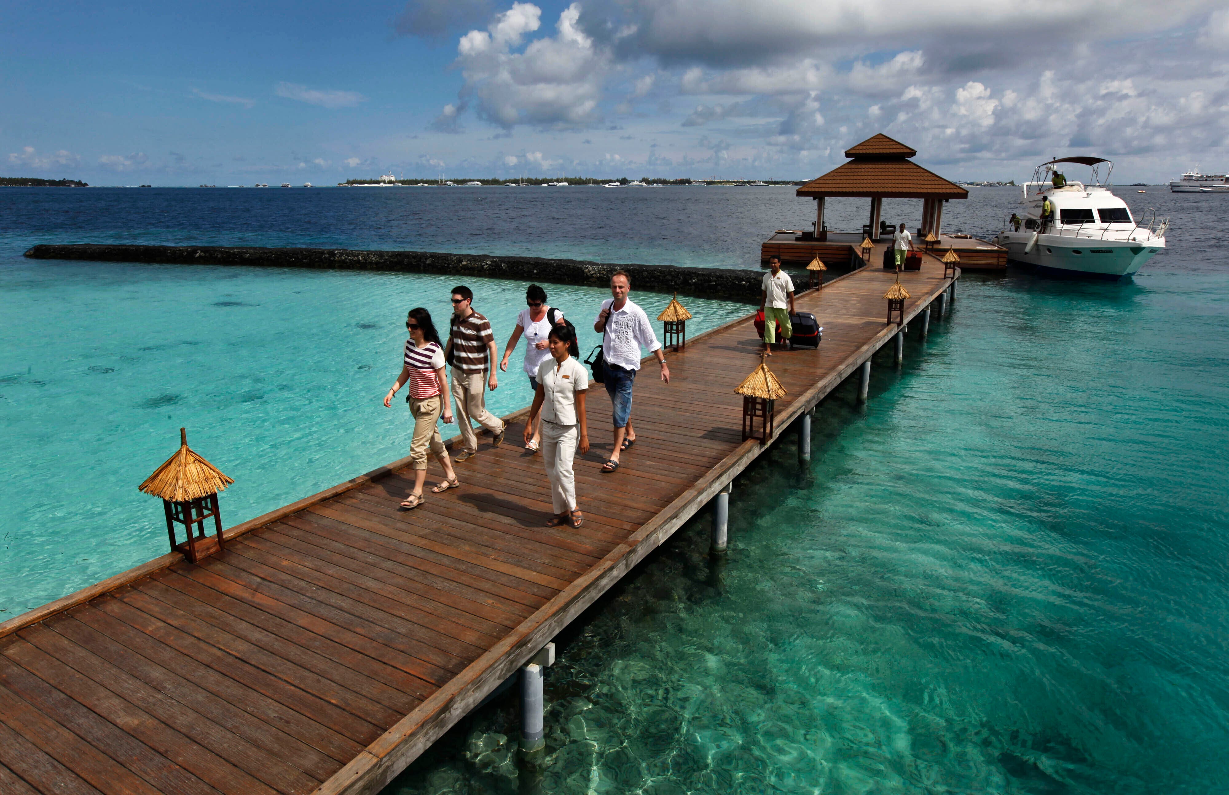 Foreign tourists arrive in a resort in the Kurumba island in Maldives