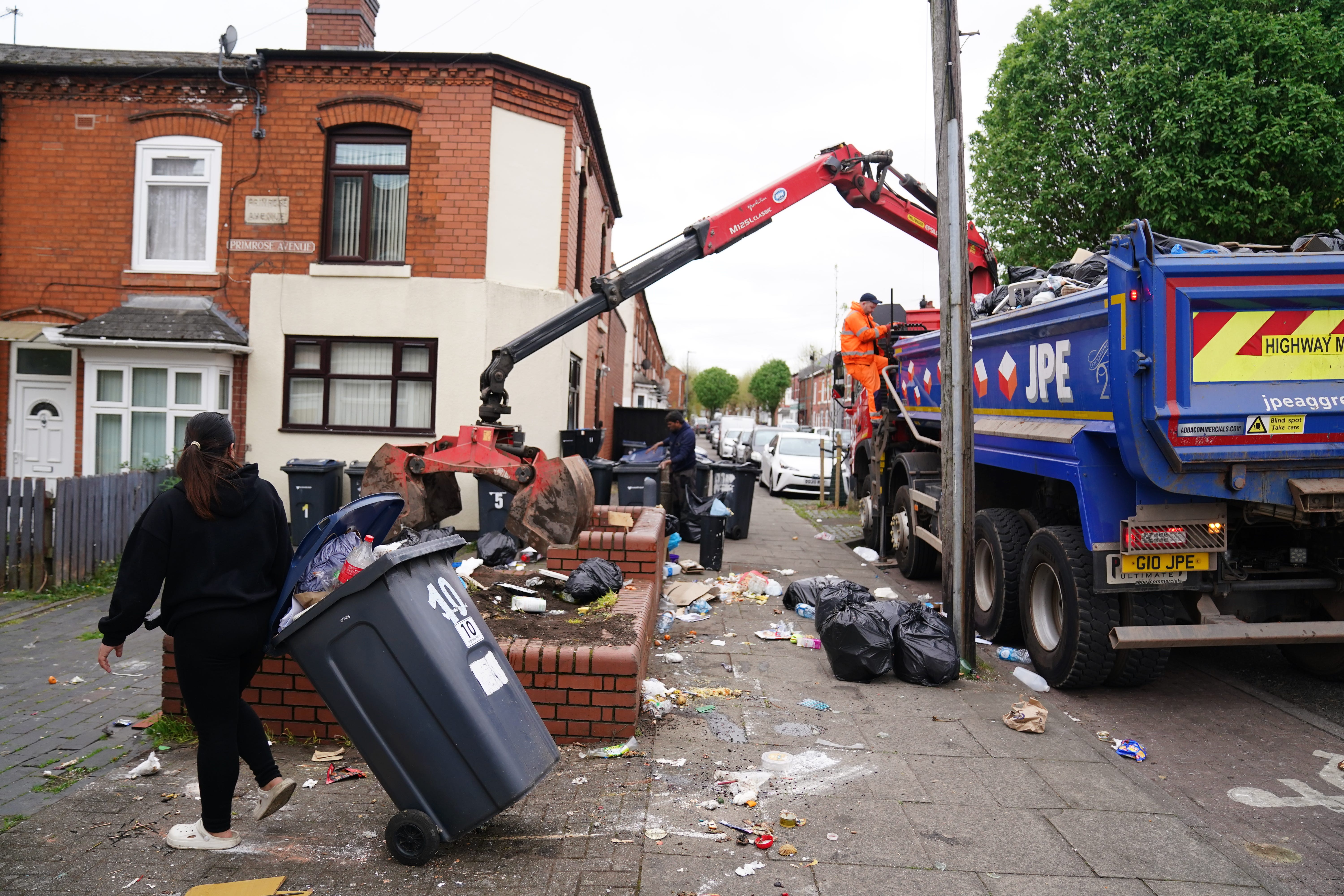 Rubbish bags are taken away on Poplar Road in Birmingham (Jacob King/PA)