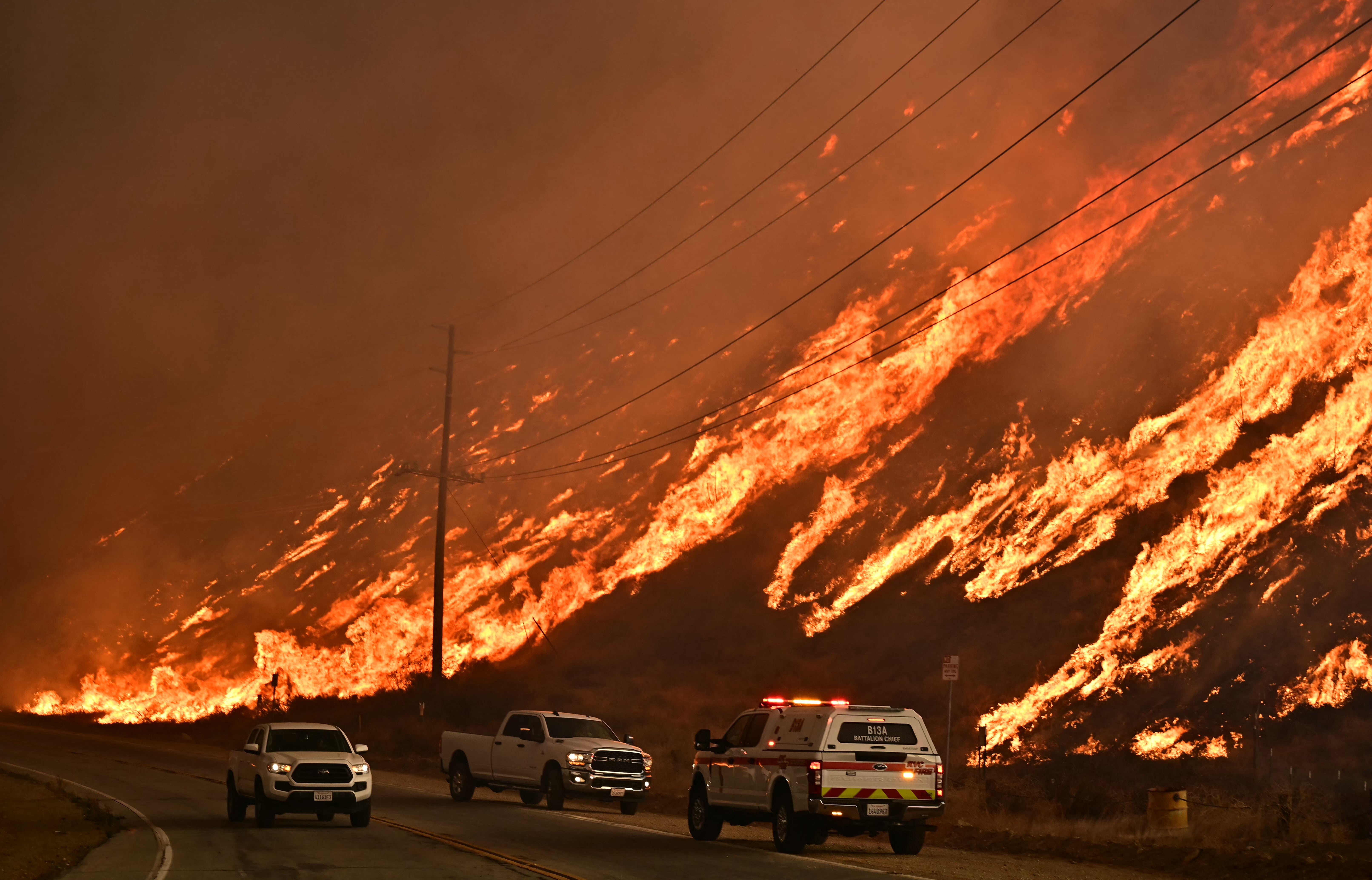 Flames from a wildfire engulf a hill in northwestern Los Angeles, California, in January