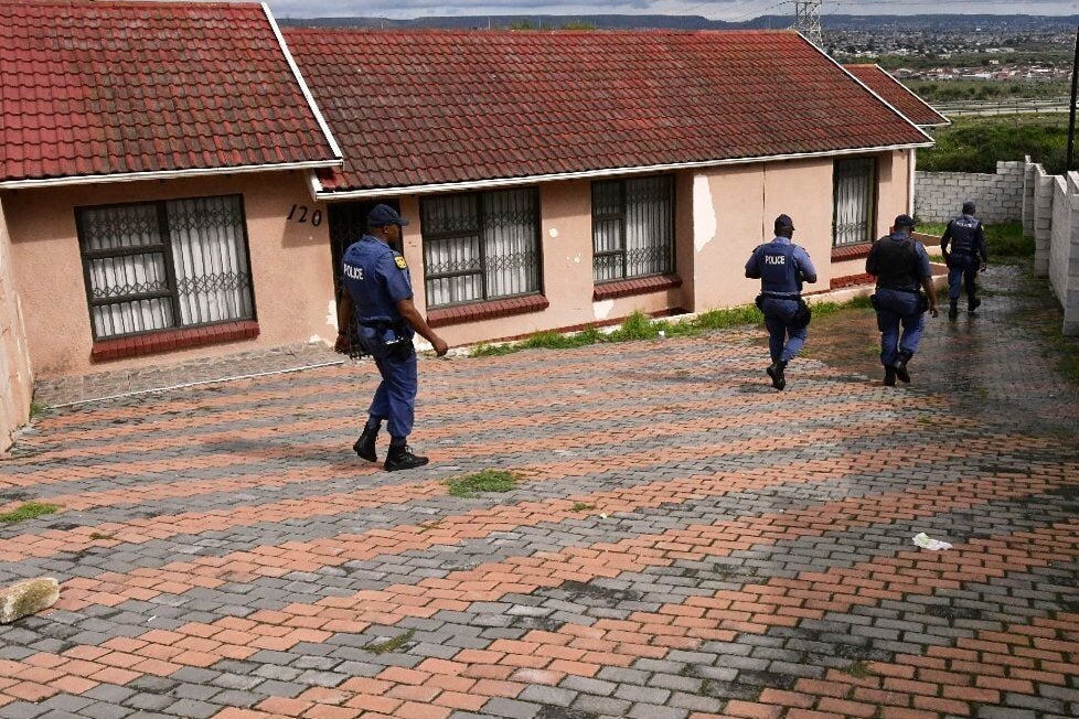 South African law enforcement officers at the house where Mr Sullivan was being held in KwaMagxaki, Gqeberha