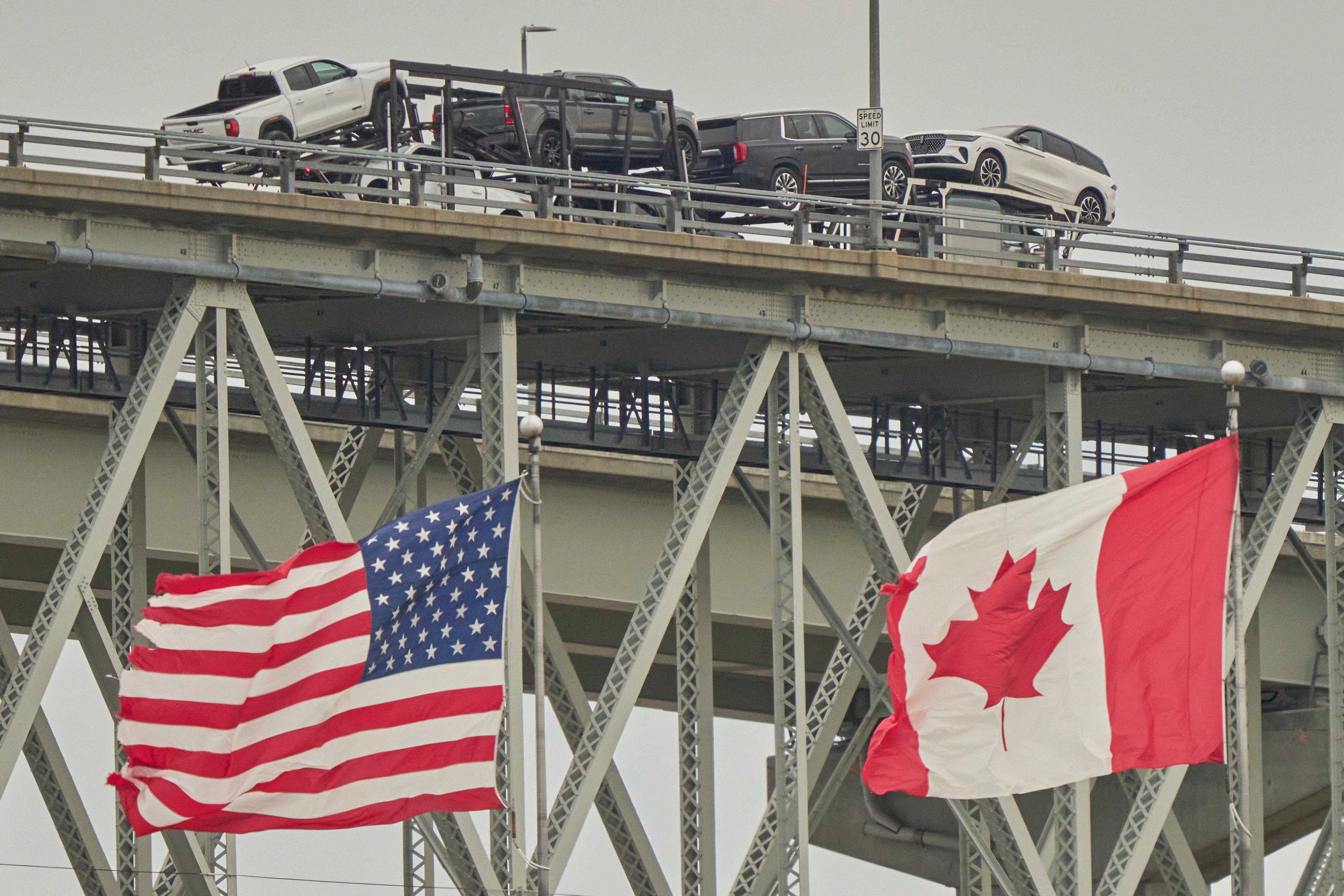 A truck hauling vehicles crosses the Blue Water Bridge border into the United States from Sarnia, Ontario, Canada in early April. Canadian travel to the U.S. has decreased for four months in a row