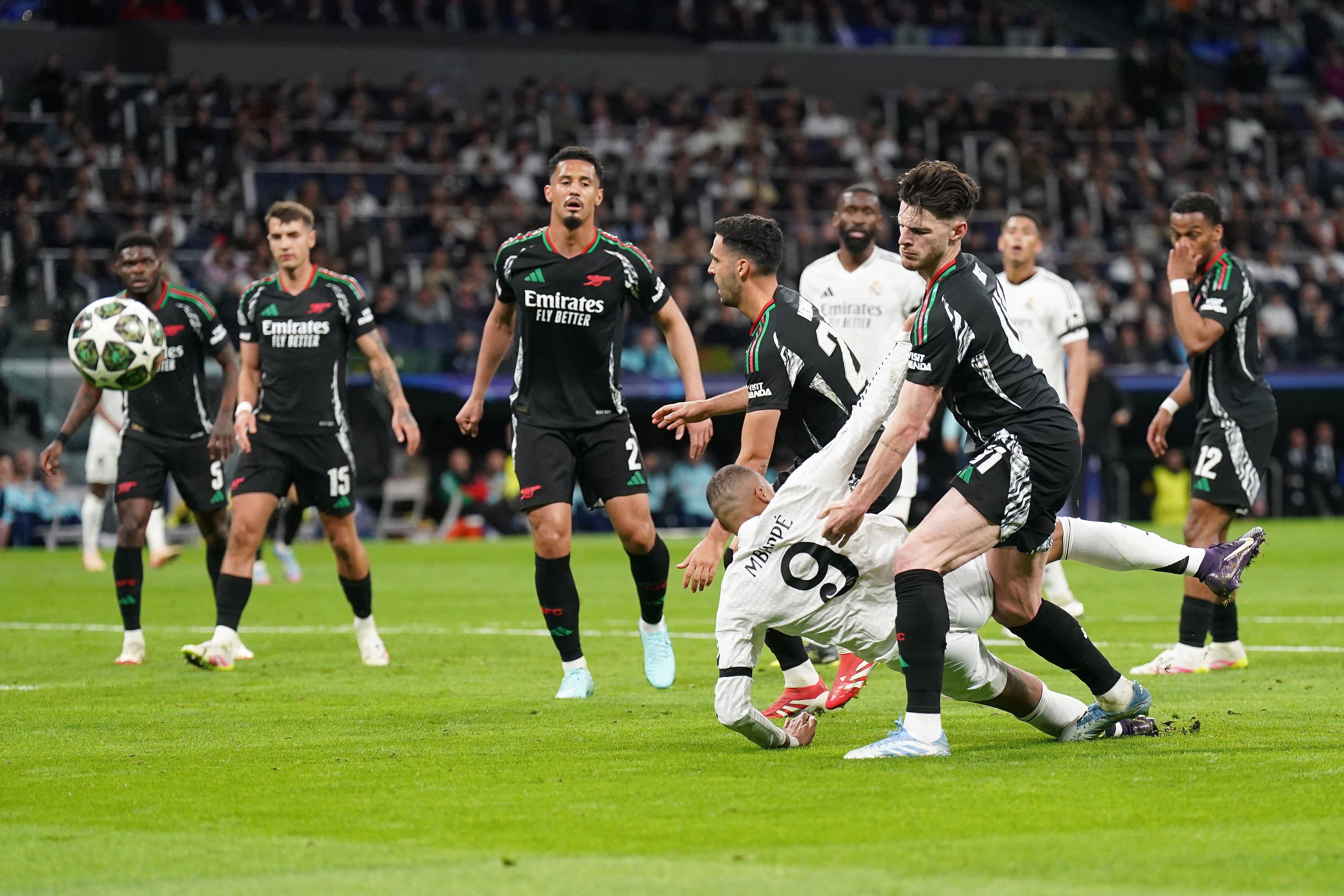 Kylian Mbappe goes to ground under pressure from Declan Rice