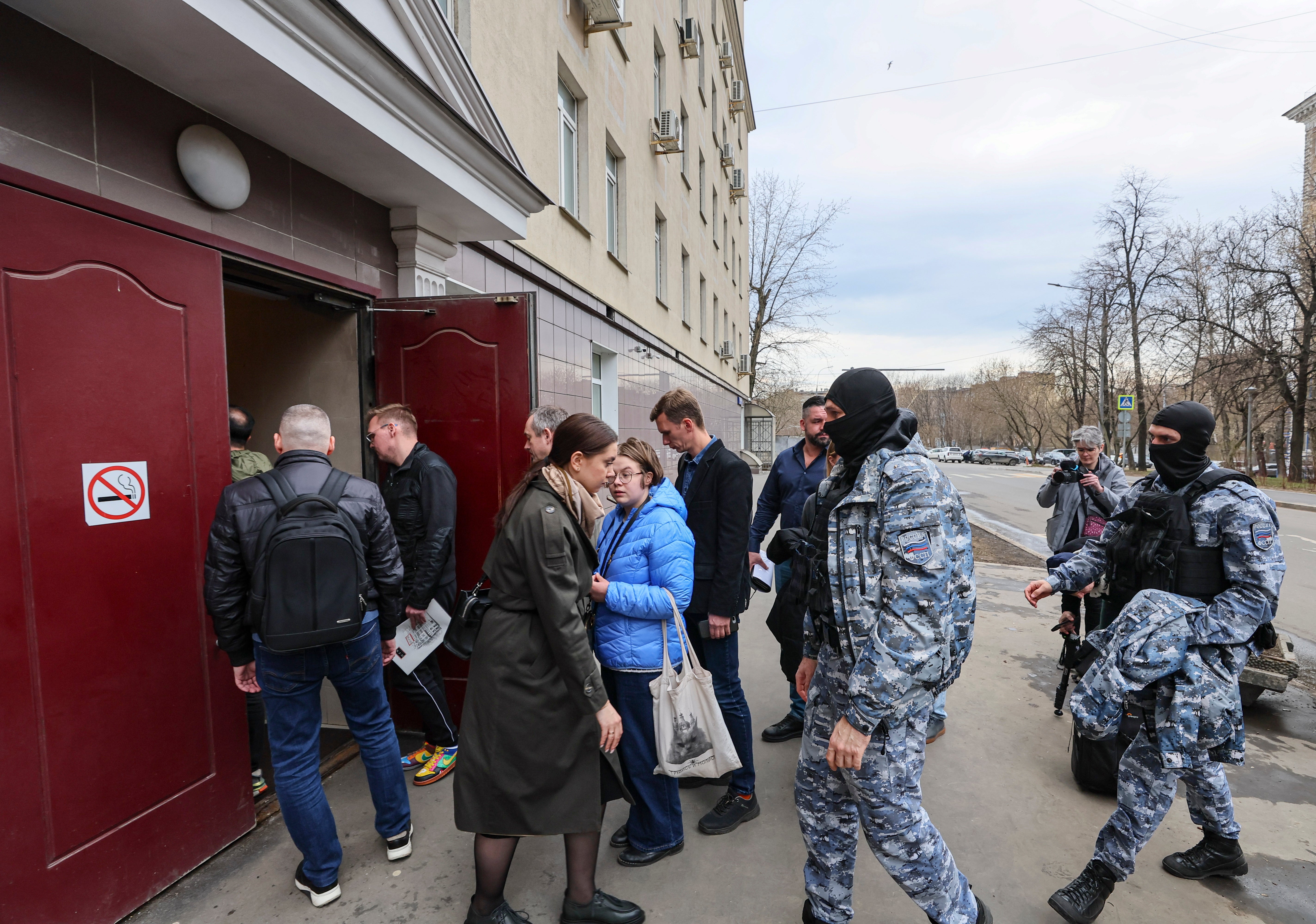 People enter a court building to attend a hearing of four Russian journalists at the Nagatinsky District Court in Moscow, Russia, 15 April 2025