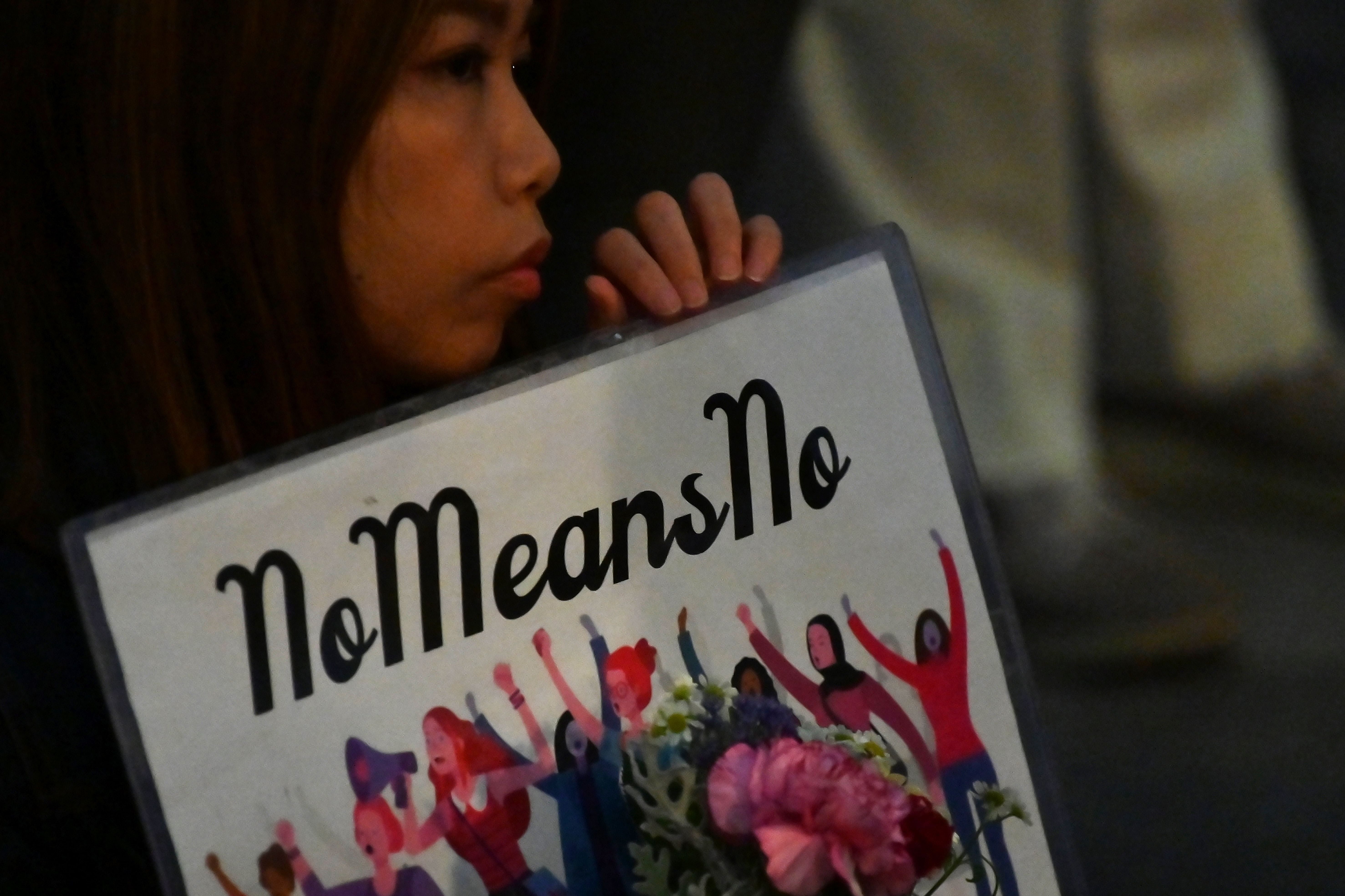 A demonstrator holds a placard during a protest against the lack of substantial legal protection for sexual assault victims in Tokyo on 11 June 2019