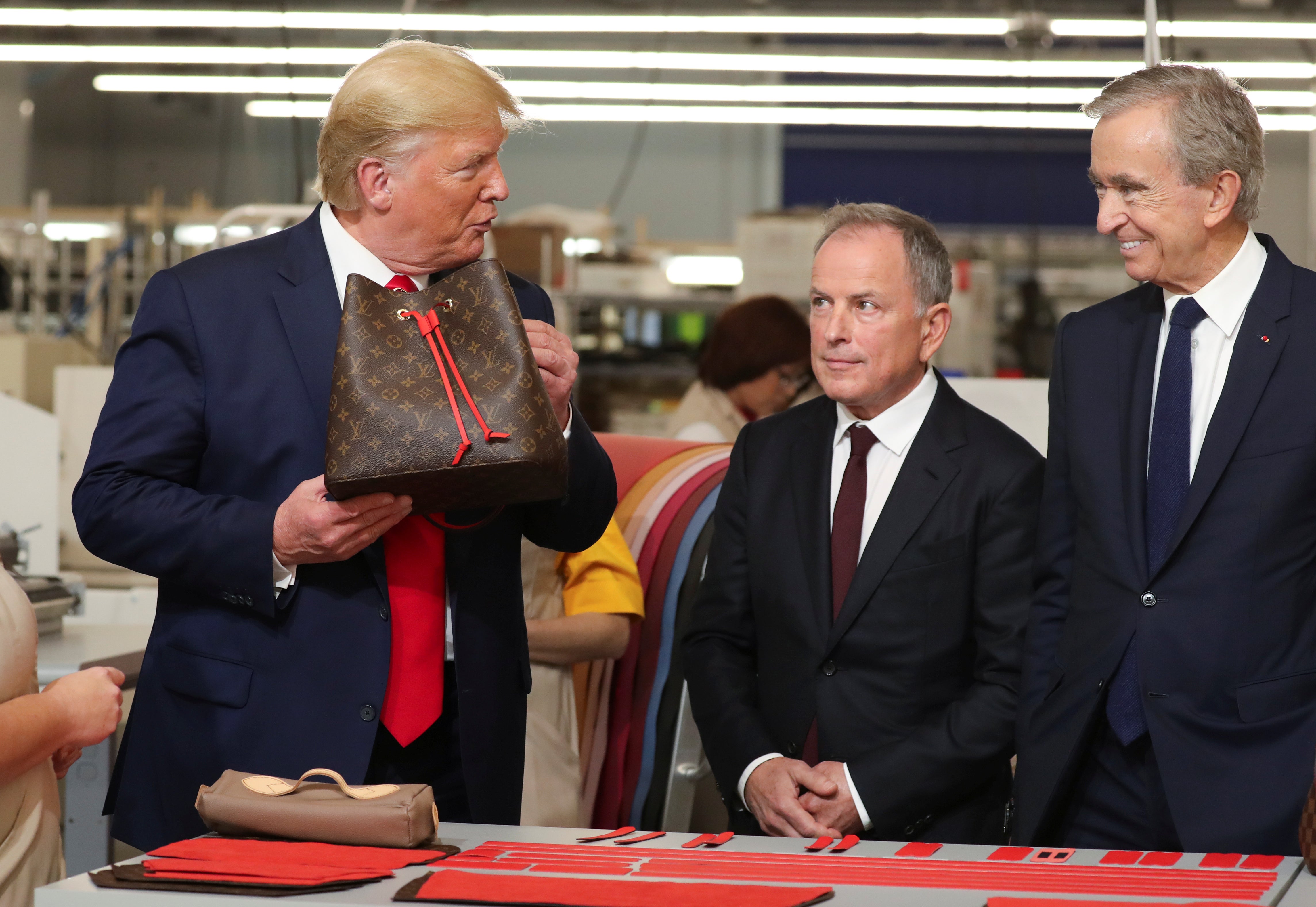 Donald Trump holds a Louis Vuitton purse during a workshop tour in 2019. It’s getting harder and harder to differentiate the fakes from the real products over the past couple years