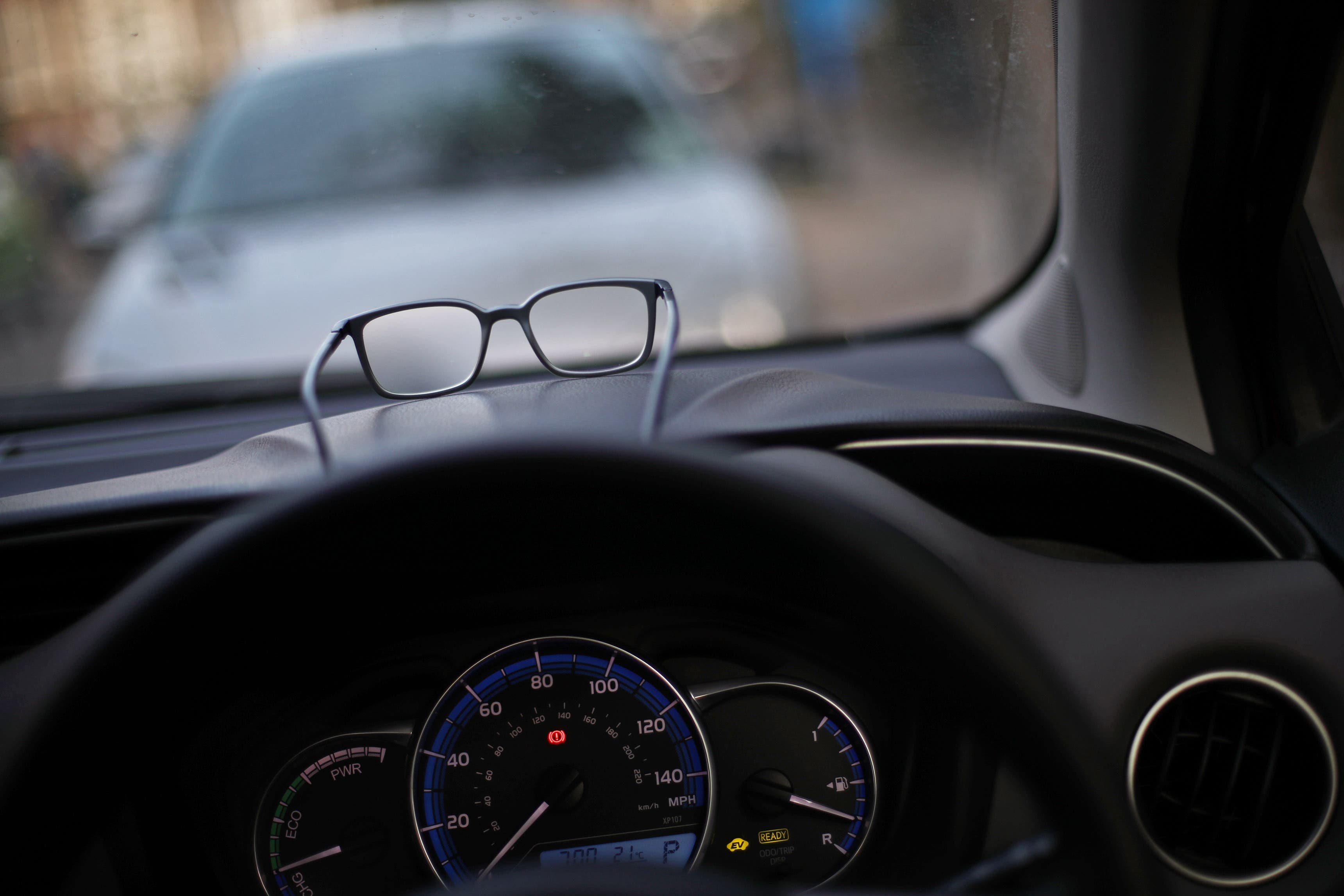A pair of glasses resting on the dashboard of a car (Yui Mok/PA)