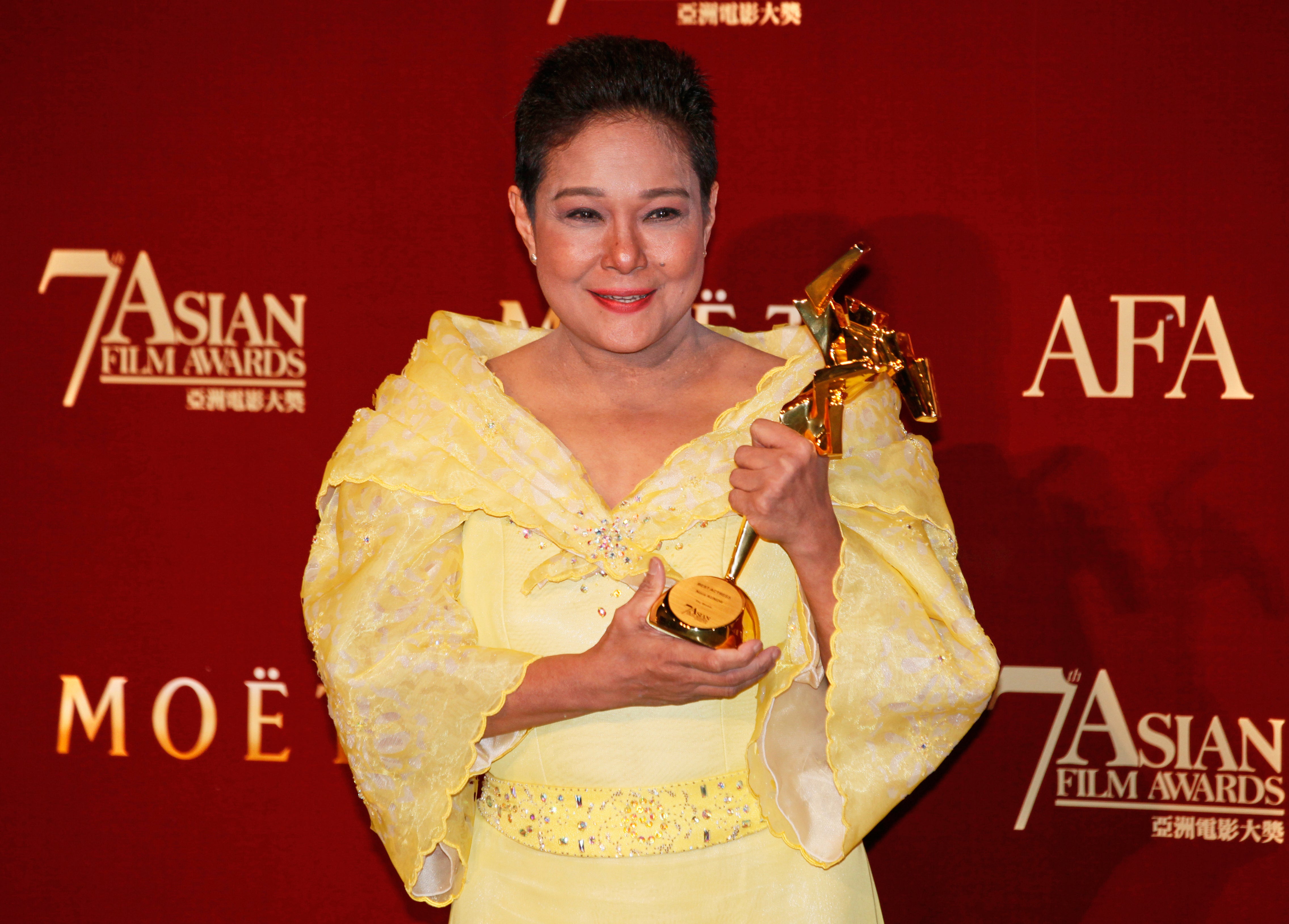 Philippine actress Nora Aunor poses with her trophy after winning the Best Actress Award for her movie Thy Womb at the Asian Film Awards