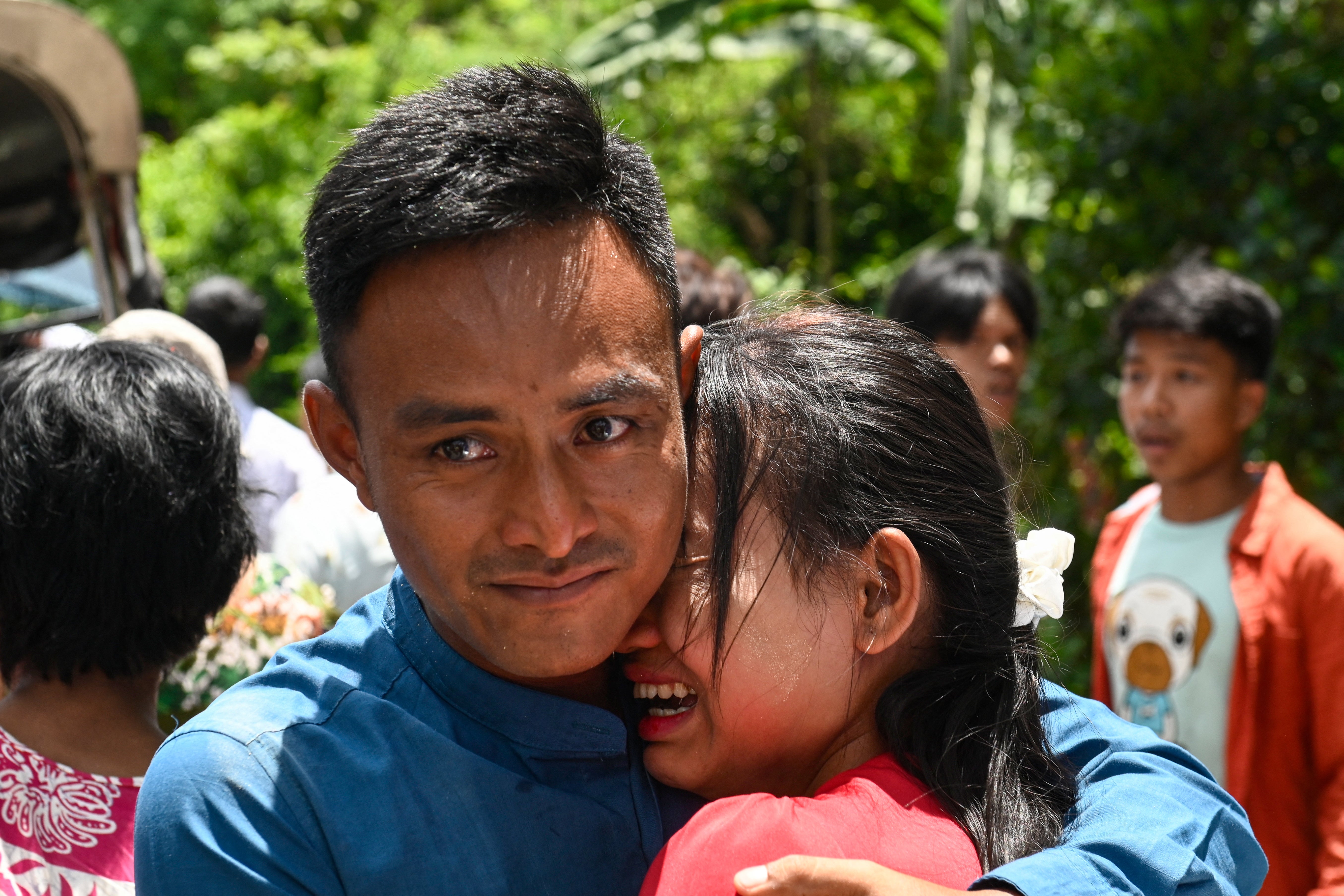 A relative celebrates with a prisoner released from Insein prison to commemorate the Buddhist New Year in Yangon on 17 April 2025