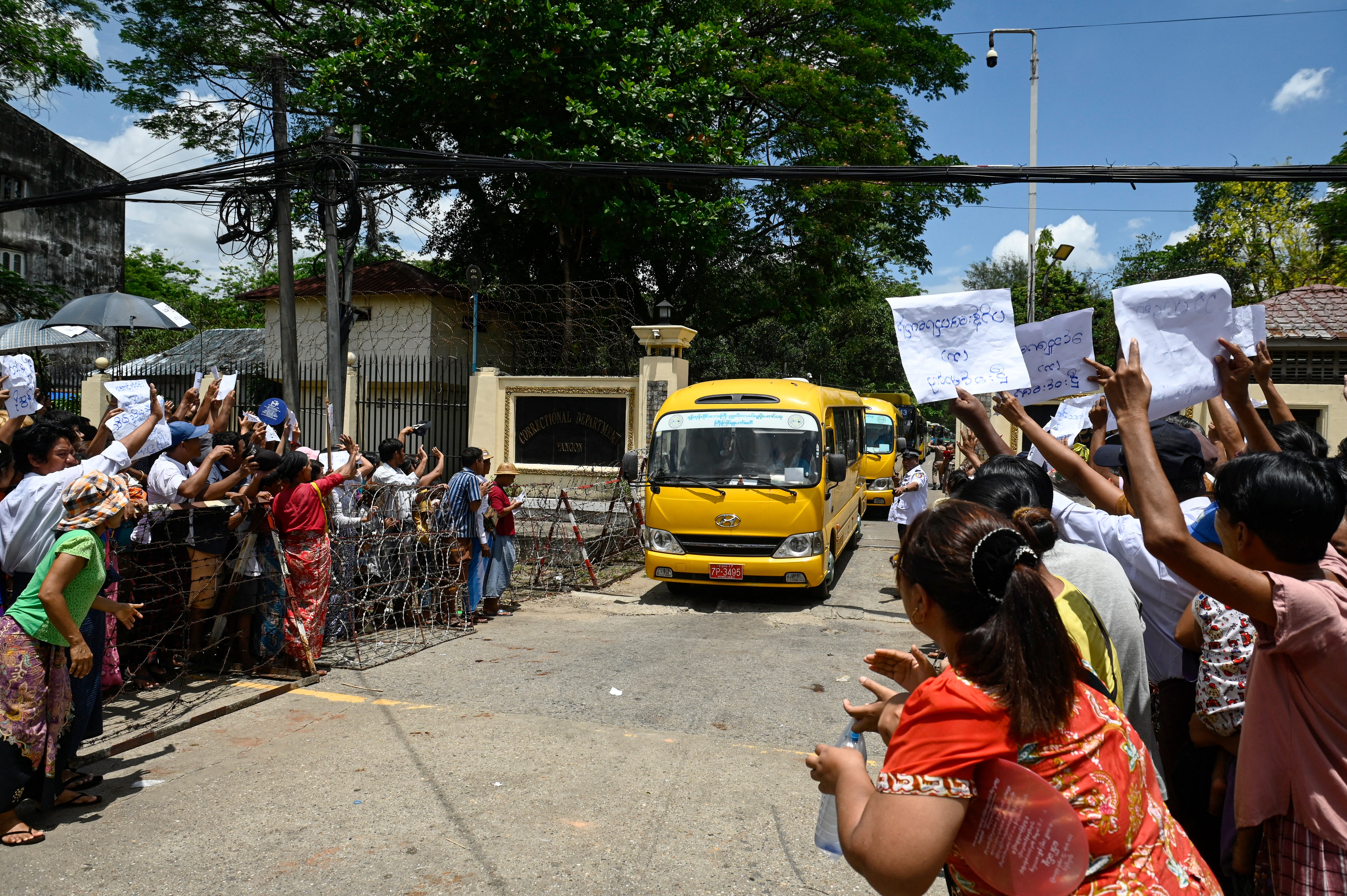 Relatives gather around a bus carrying prisoners being released from Insein prison to commemorate the Buddhist New Year in Yangon on 17 April 2025