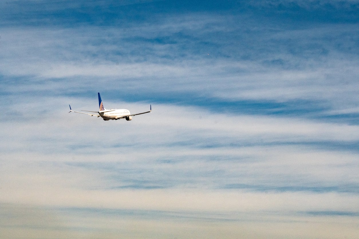 View down the runway at a United Airlines Boeing 737-800 as it gains altitude after take off from Newark Liberty Airport EWR