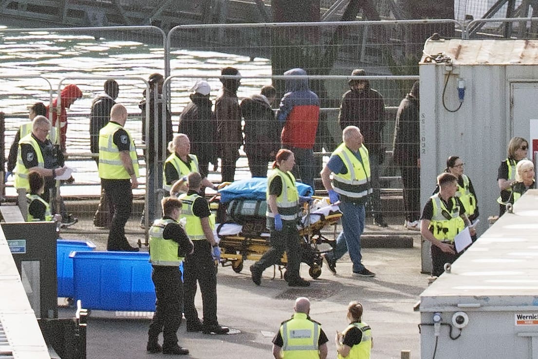 Stretcher of equipment is wheeled through the Border Force compound as a group of people thought to be migrants are brought in to Dover, Kent, from a Border Force vessel (Gareth Fuller/PA)