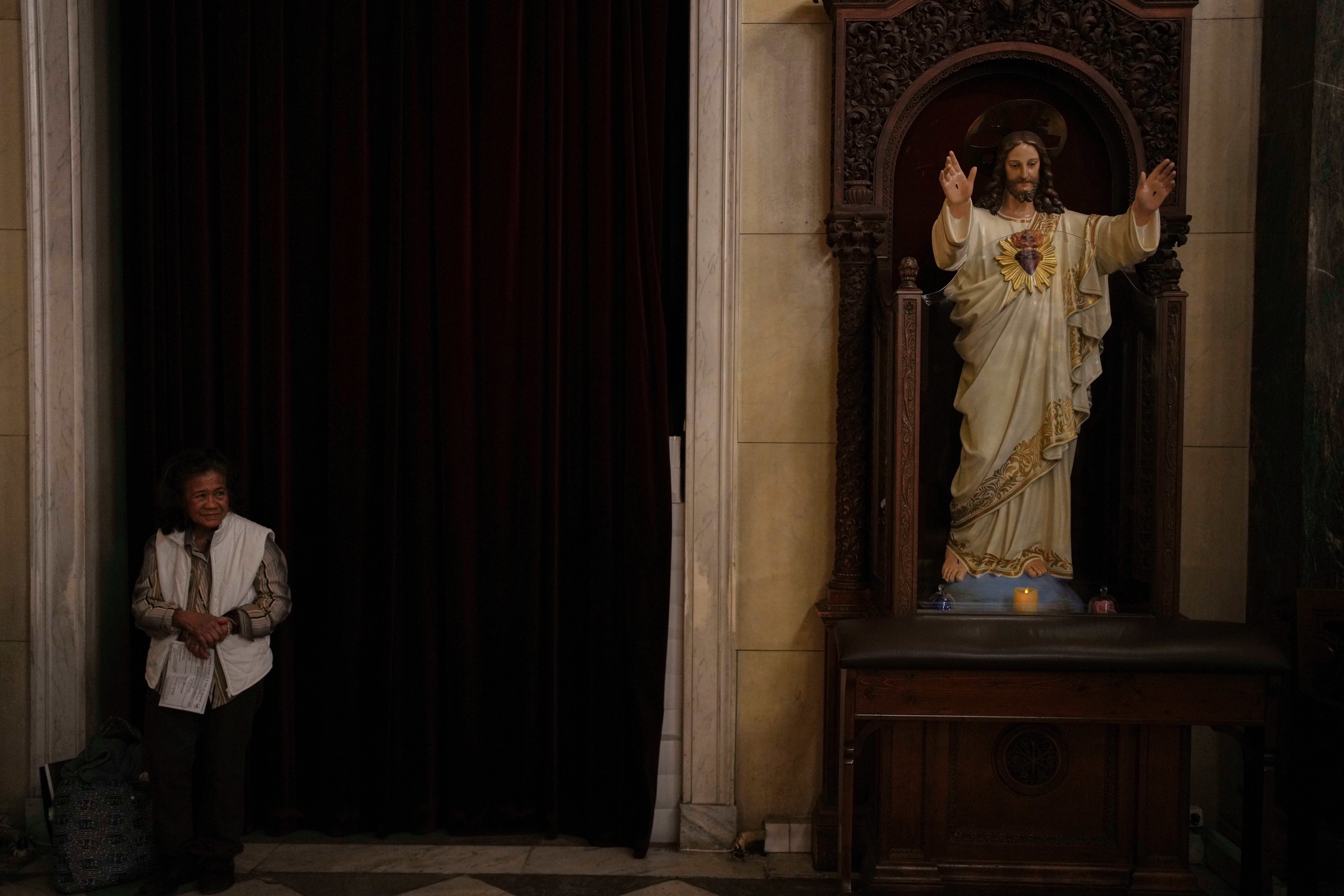 A Catholic believer attends mass in Athens, Greece