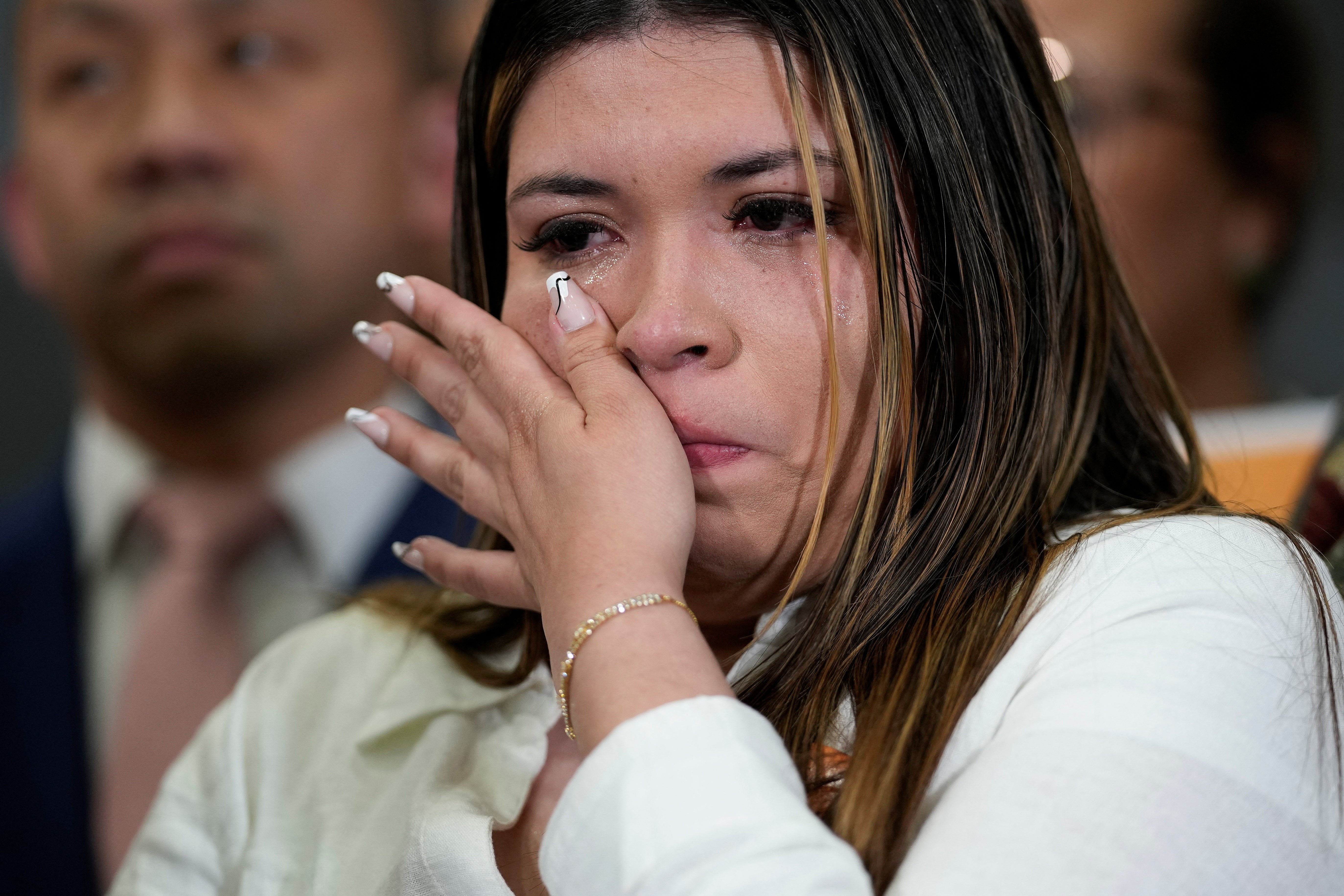 Jennifer Vasquez Sura, wife of Kilmar Abrego Garcia, a Salvadoran man deported from the U.S. to El Salvador, wipes away tears during a Friday press conference held by Maryland Sen. Chris Van Hollen