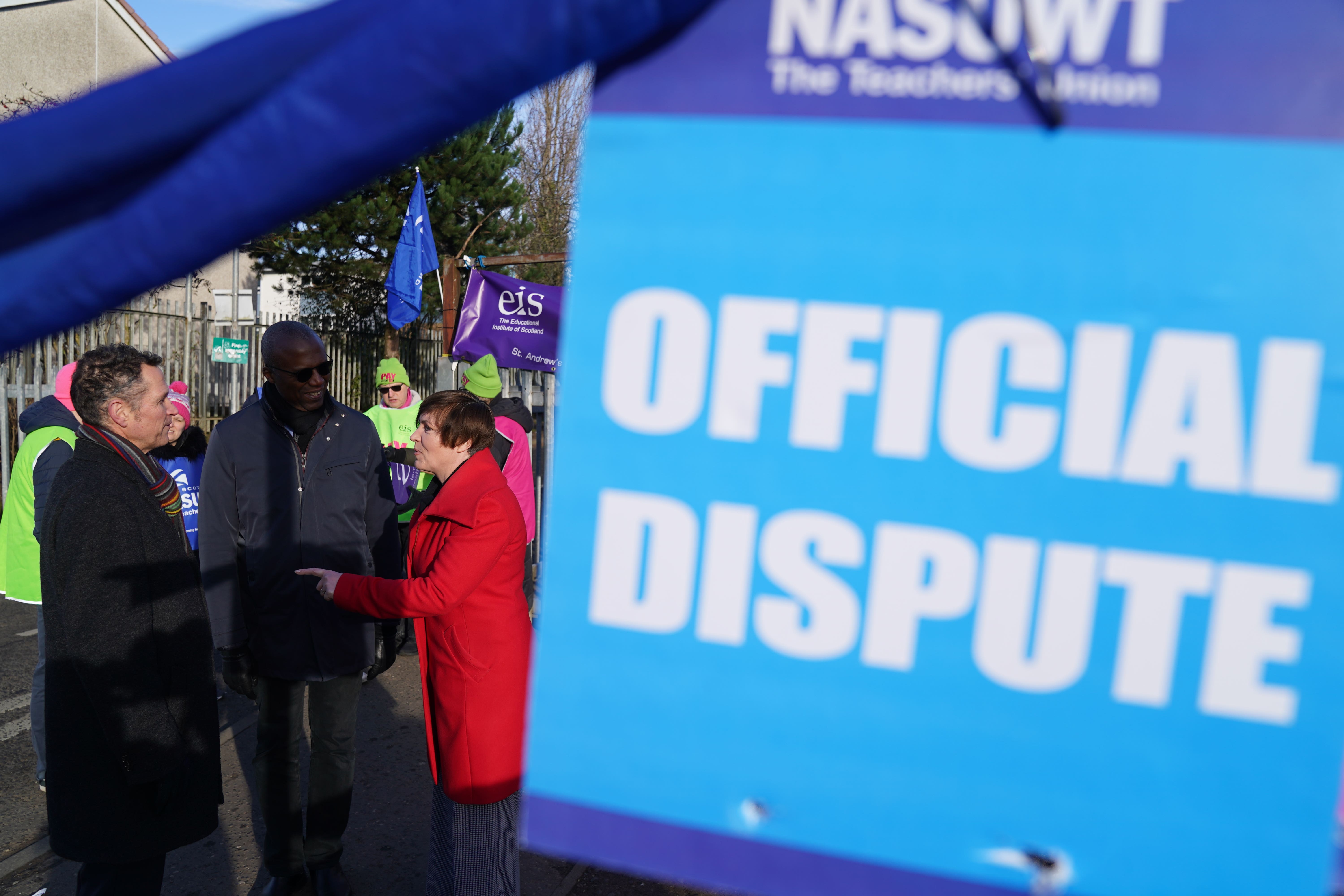 Mike Corbett, National Association of Schoolmasters Union of Women Teachers (NASUWT) Official for Scotland, Dr Patrick Roach, general secretary of the NASUWT, and Scottish Trades Union Congress (STUC) general secretary Roz Foyer, with teachers on the picket line outside St. Andrew’s RC Secondary School in Glasgow, as they take strike action in a dispute over pay (Andrew Milligan/PA)
