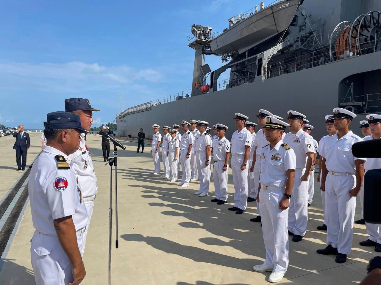 Japanese navy officers, right, line up as their warship dock at a naval base's pier during a four-day visit at the Ream Naval Base, Cambodia, 19 April 2025. (Japanese Embassy to Cambodia via AP)