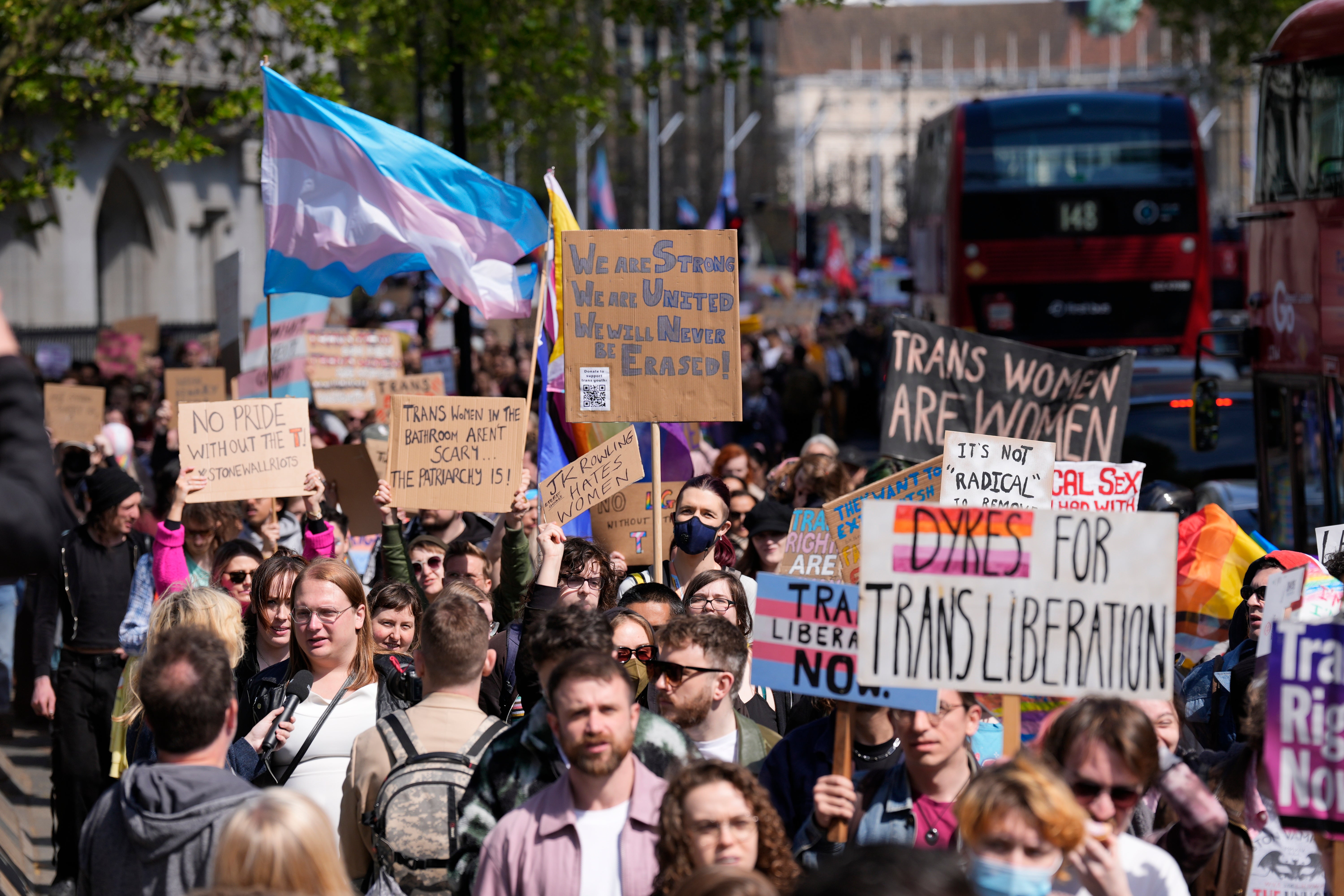 Campaigners take part in a rally organised by trans rights groups, trade unions, and community organisations at Parliament Square in central London on Saturday