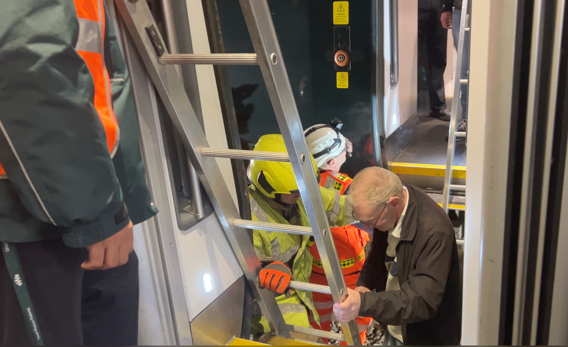 Safety first: rail staff help passengers transfer from a stricken GWR train to a replacement