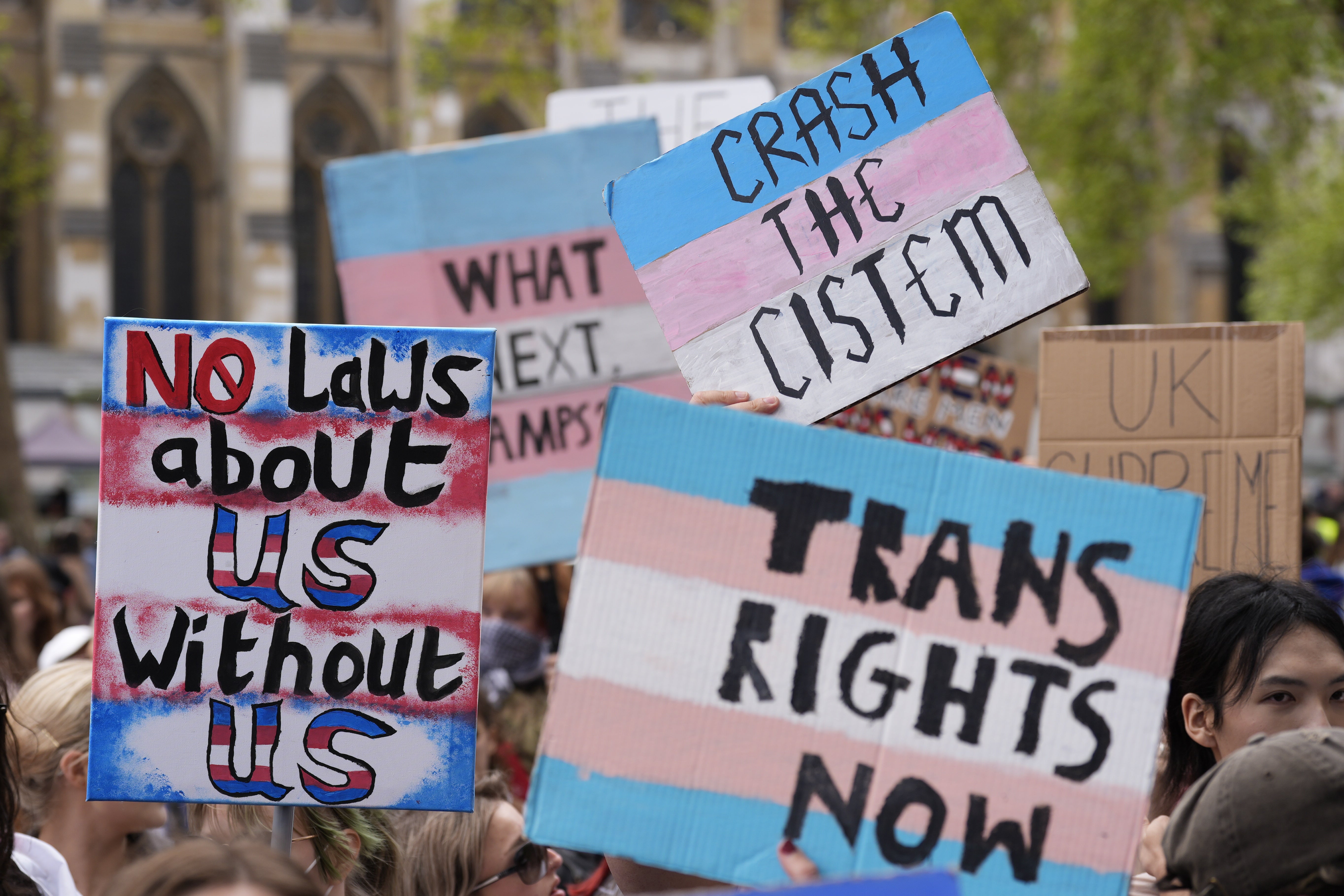 Campaigners take part in a rally organised by trans rights groups, trade unions, and community organisations in London on Saturday
