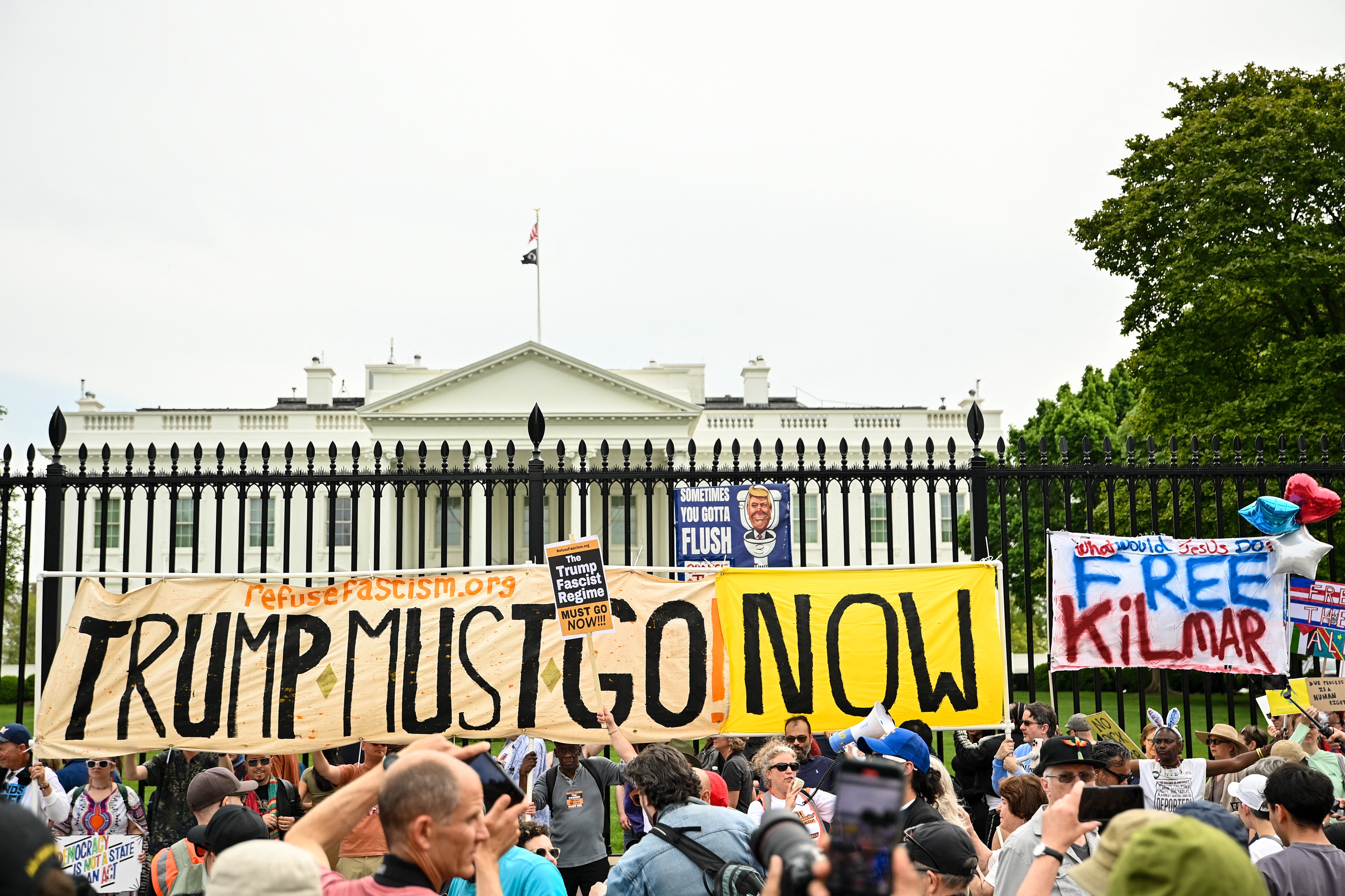 Demonstrators hold up signs outside of the White House calling for Abrego Garcia’s release and for Trump to ‘go now’