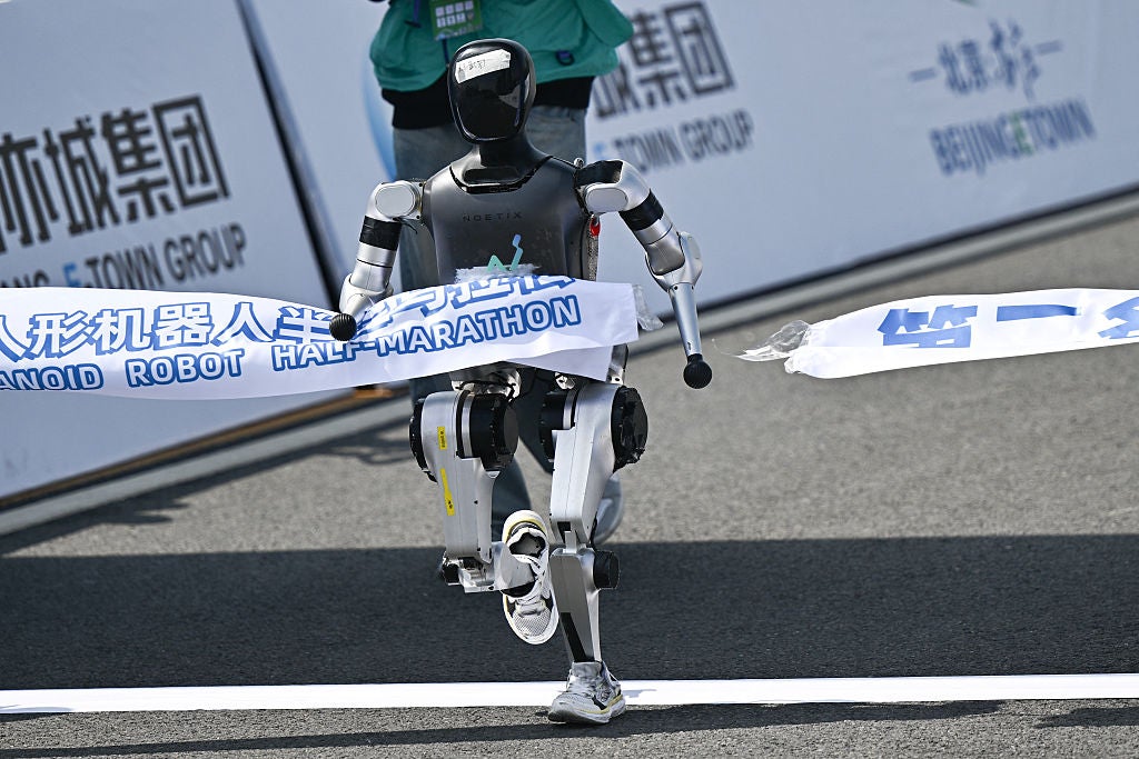 A robot crosses the finish line in the humanoid robot half marathon in Beijing