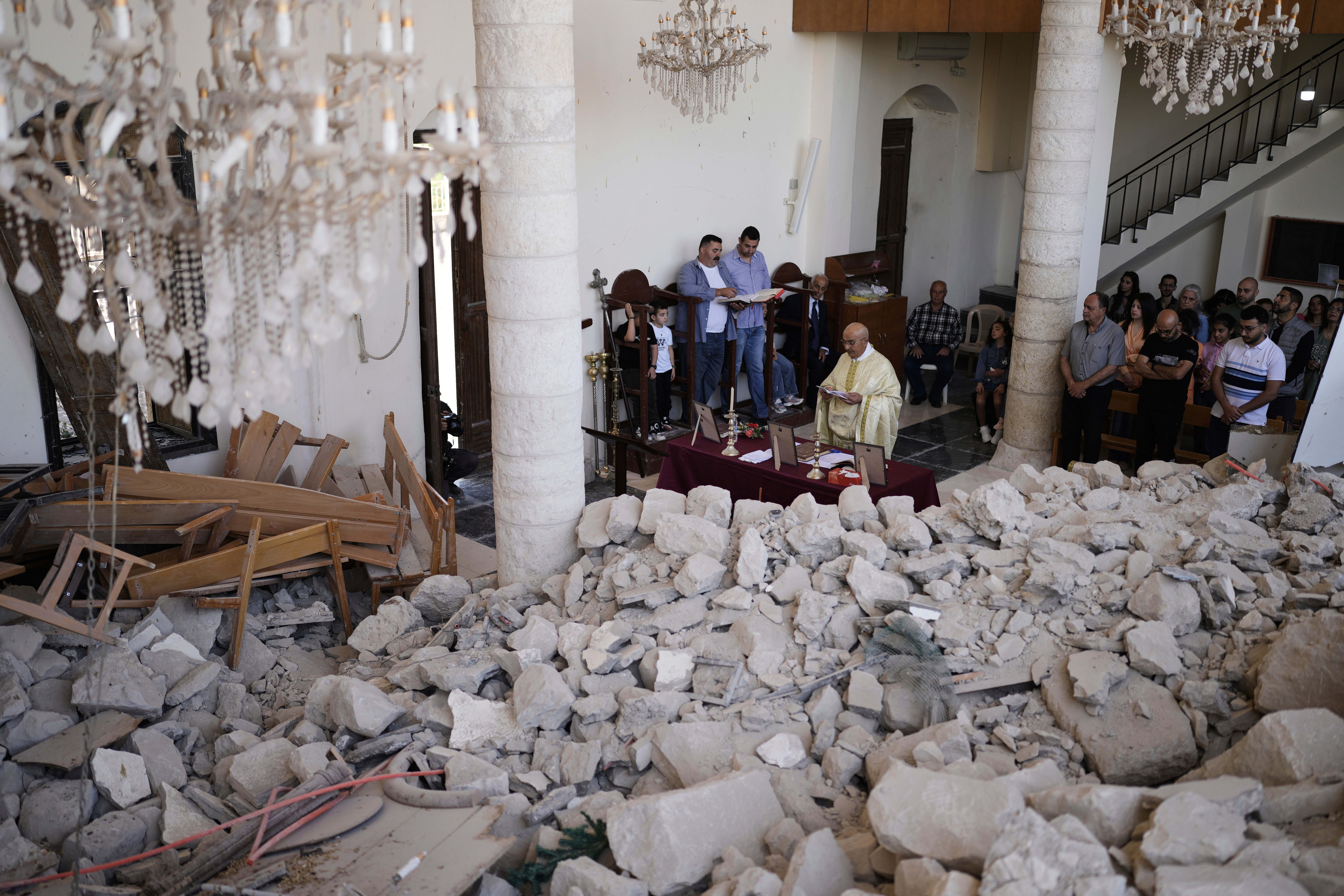 Worshippers gather for Easter Mass inside the ruins of St George Melkite Catholic Church in Dardghaya, southern Lebanon, on Sunday, after the church was heavily damaged in an Israeli airstrike earlier in the conflict
