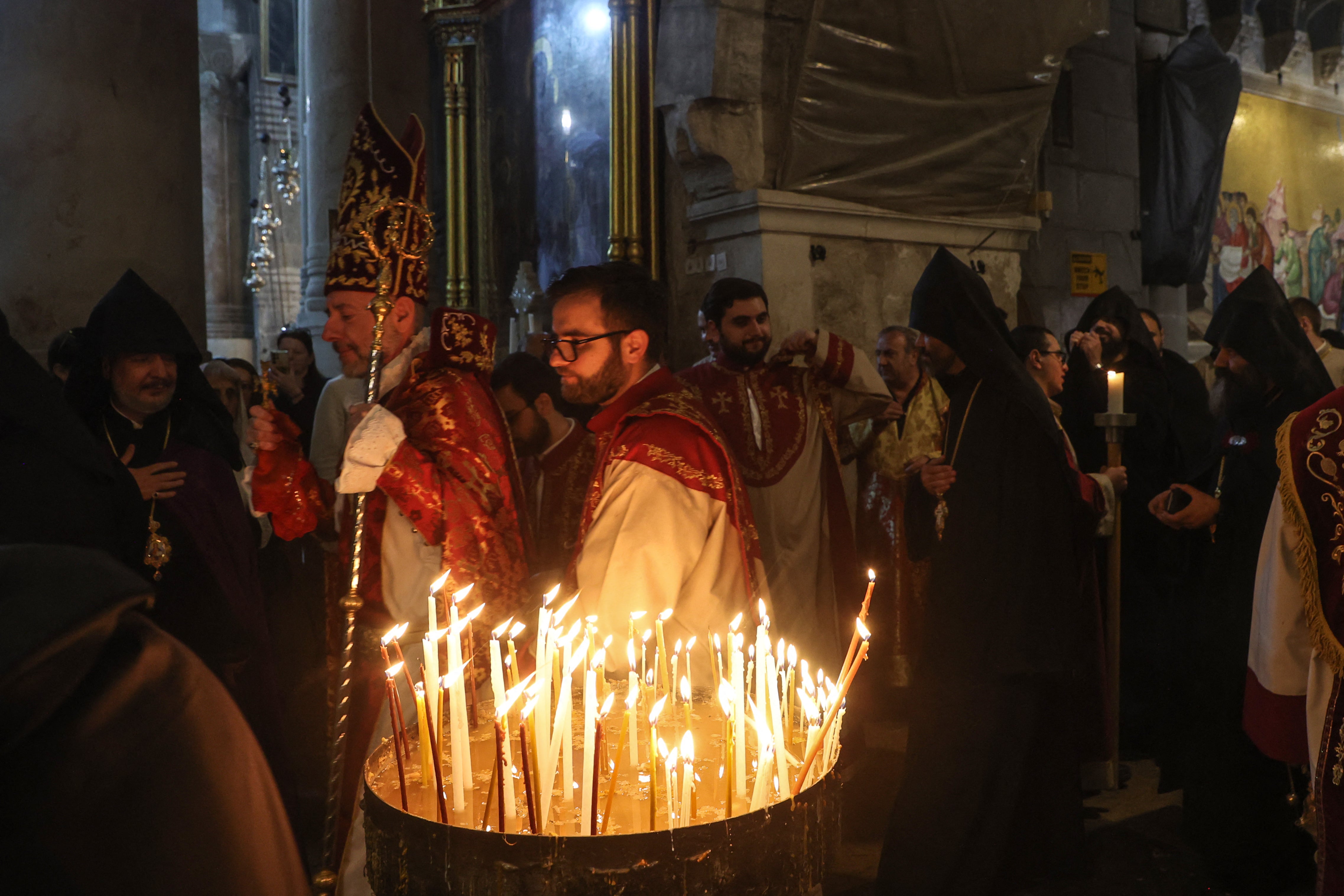 Members of the Armenian clergy arrive to celebrate the Easter mass at the Holy Sepulchre Church in Jerusalem's Old City on Sunday