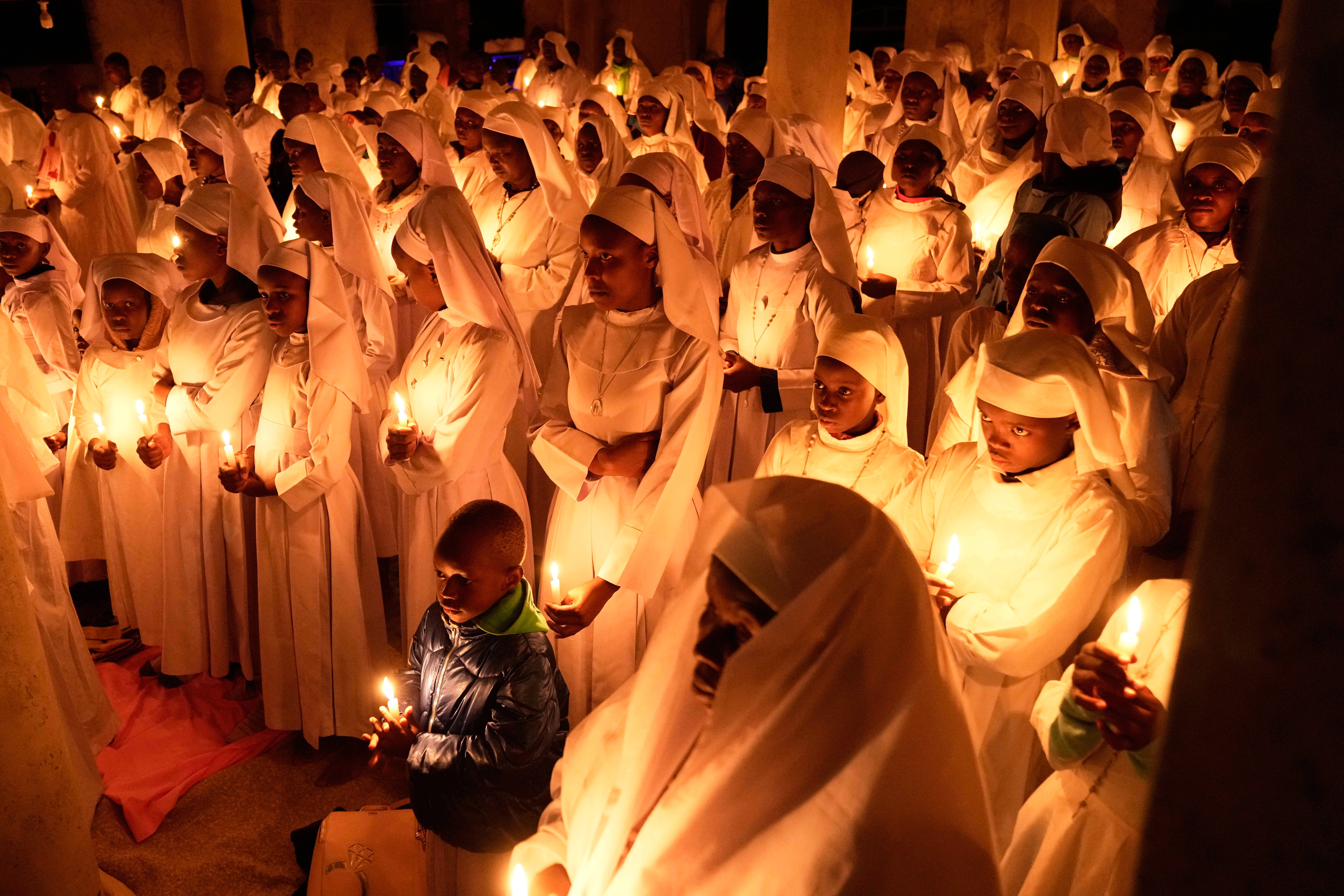 Christian faithful of the Legio Maria African Mission attend the Easter vigil Mass in the informal settlement of Kibera in Nairobi, Kenya, on Saturday