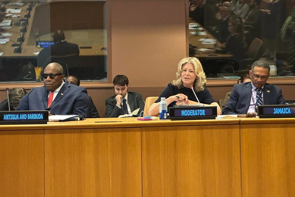 This undated photo shows moderator Laura Trevelyan, center, with Antigua’s U.N. Ambassador Walton Webson, left, and Jamaica’s U.N. Ambassador Brian Wallace, right, during a meeting of descendants of slave owners and slaves in former British colonies in the Caribbean at U.N. headquarters