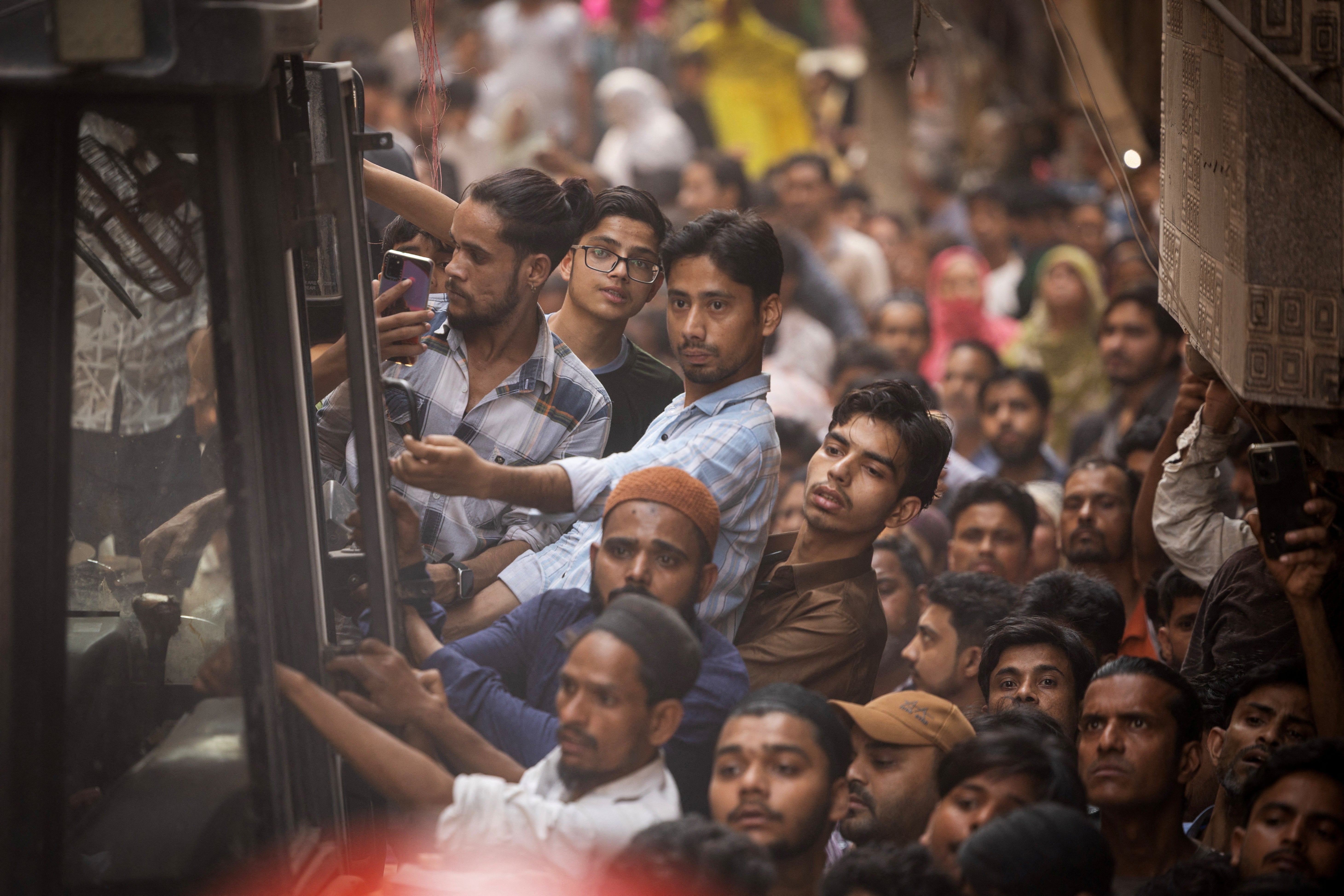 People gather at the site of a collapsed building