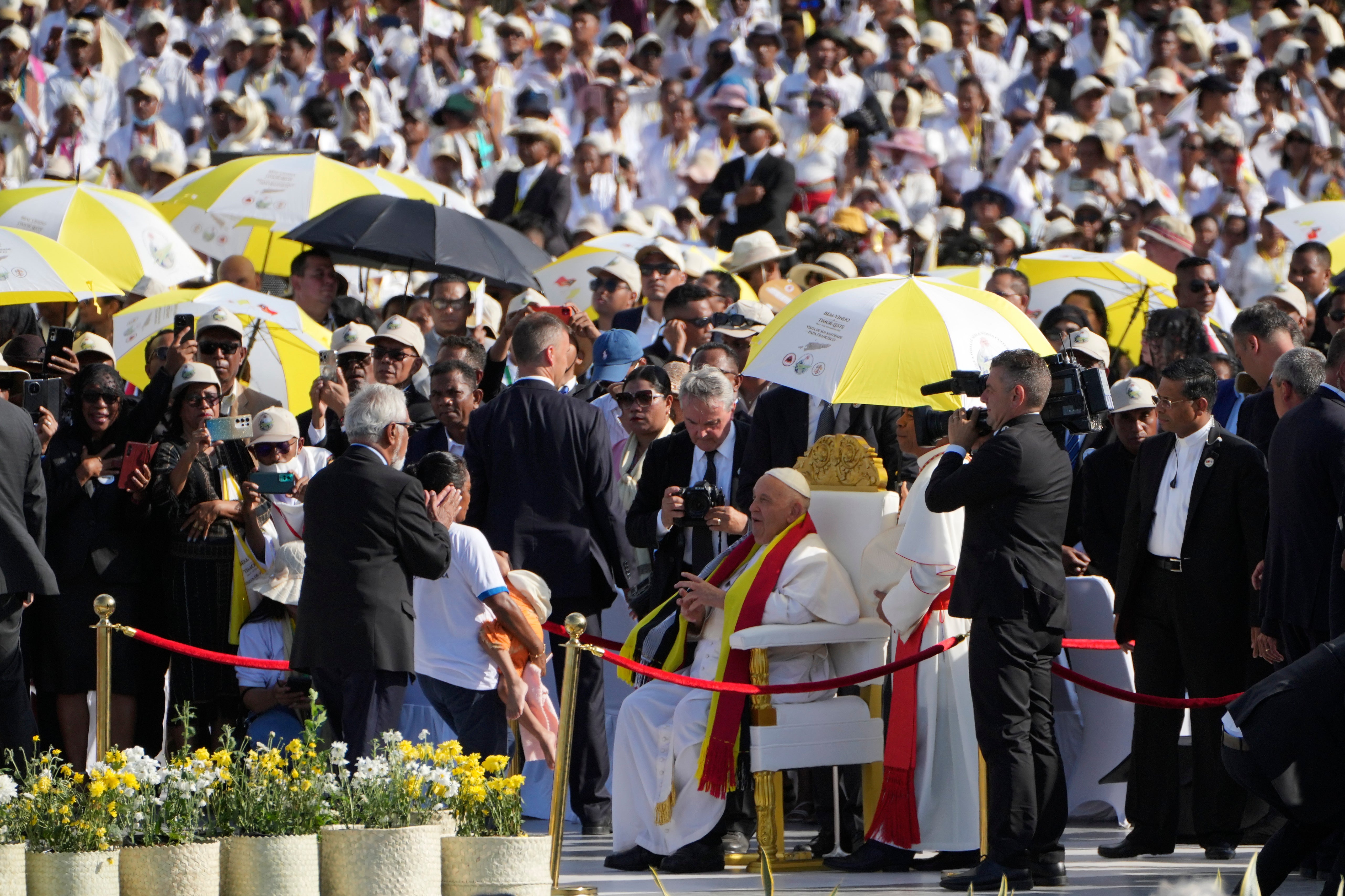 Pope Francis is seated before leading a holy mass at Tasitolu park in Dili, East Timor