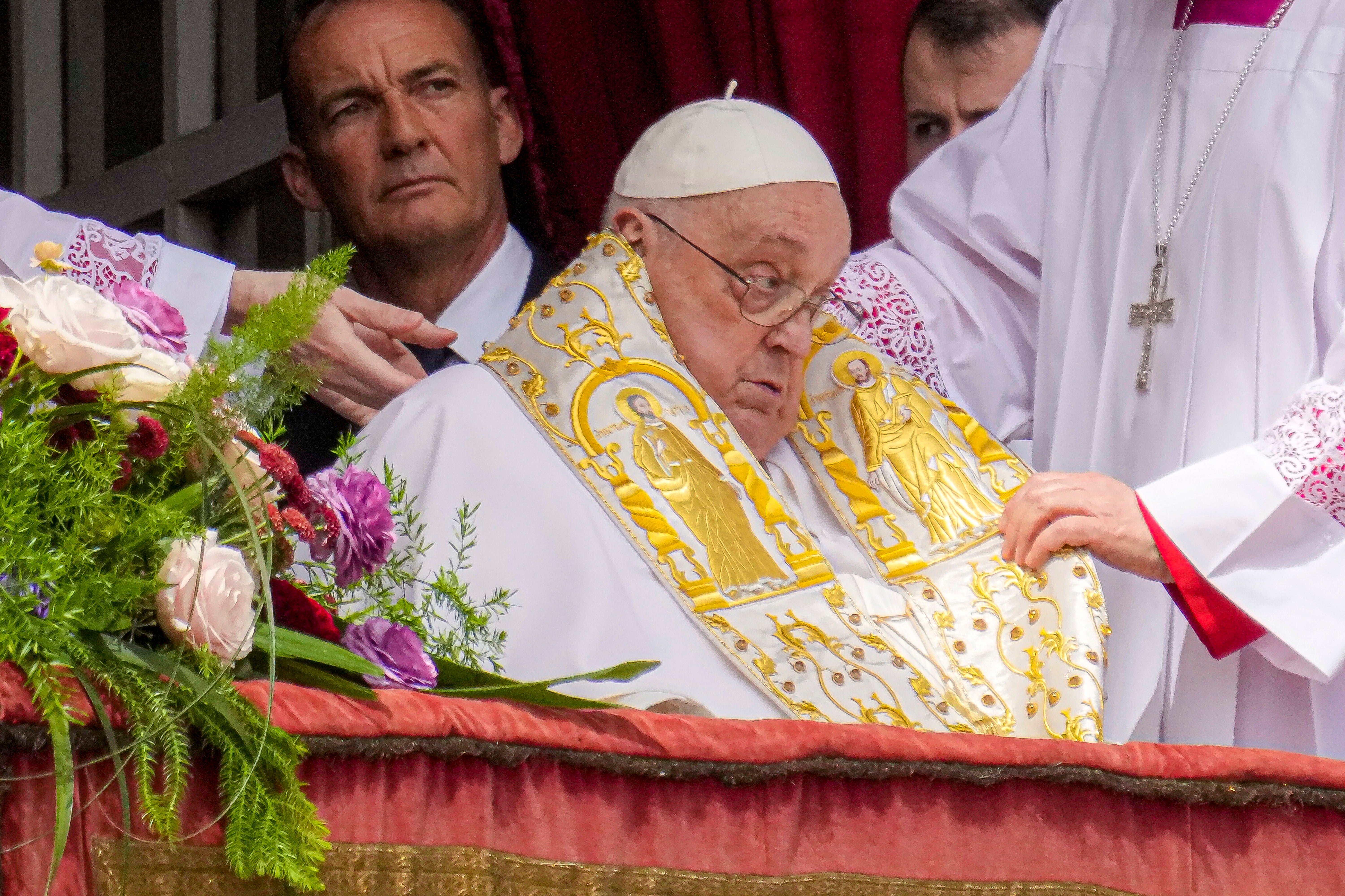 Pope Francis appears on the central lodge of St Peter’s Basilica to bestow a blessing on Easter Sunday (Gregorio Borgia/AP)