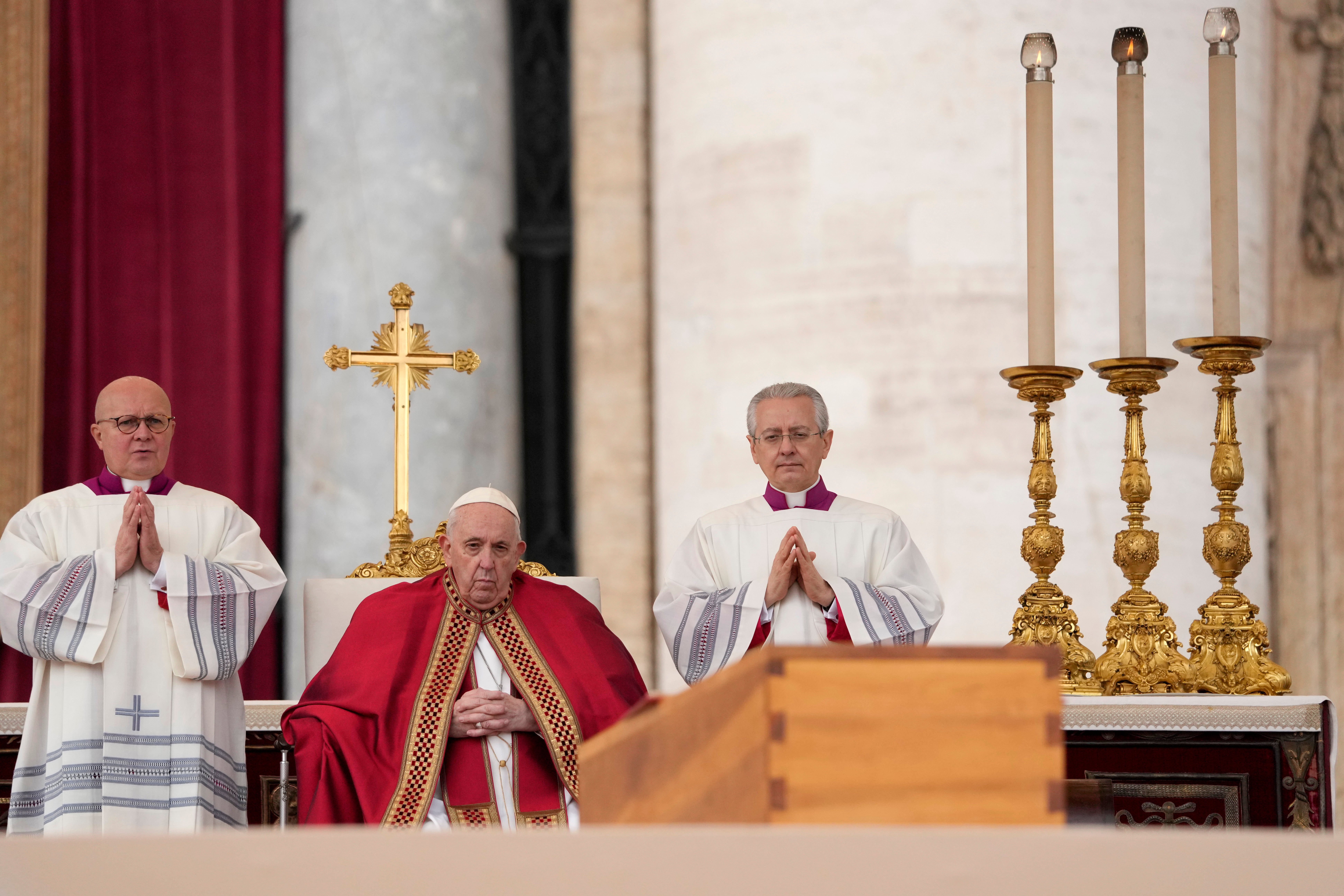 Pope Francis sits by the coffin of late Pope Emeritus Benedict XVI in St Peter’s Square during a funeral mass at the Vatican, on 5 January 2023 (AP Photo/Andrew Medichini)