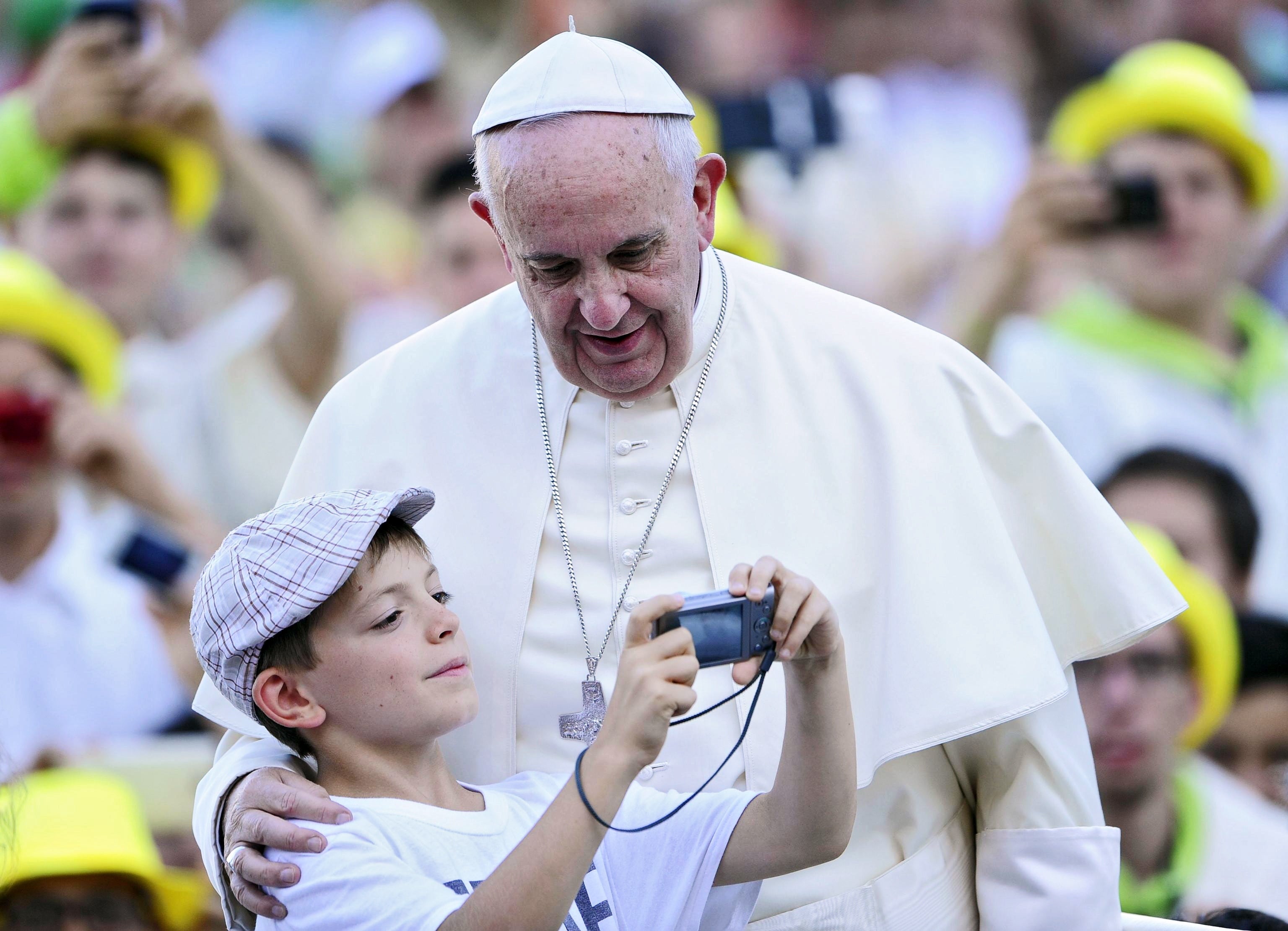 Pope Francis poses for a picture with a child during the meeting with thousands of altar boys in St Peter's Square, Vatican City