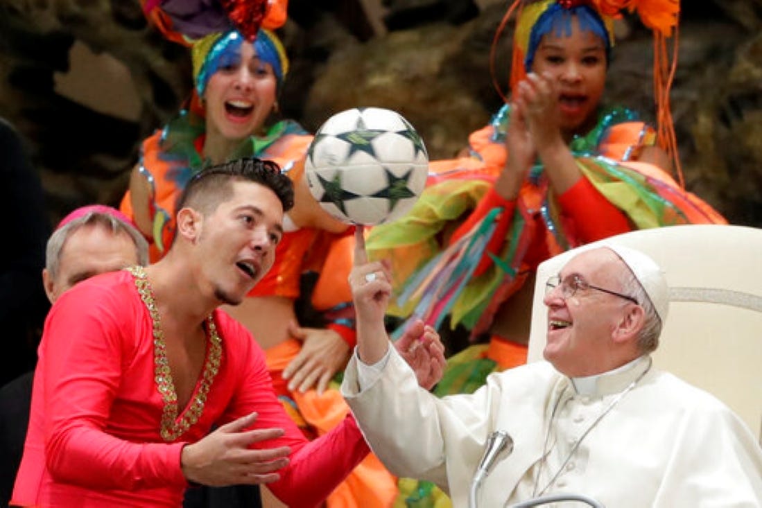 Pope Francis twirls a football presented by a member of the Circus of Cuba, during his weekly general audience in the Vatican in 2019 (AP)