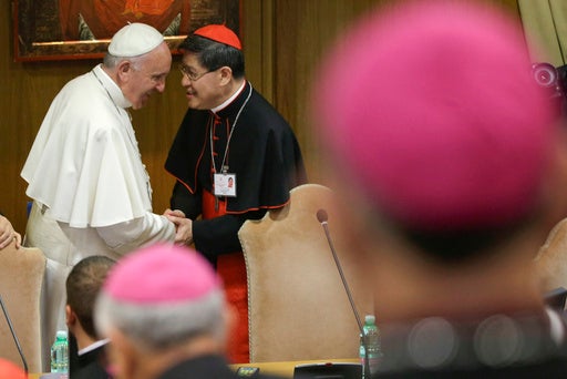 In this Monday, 5 Oct 2015 file photo, Pope Francis is greeted by Cardinal Luis Antonio Tagle, right, upon his arrival at the opening session of a two-week bishops' meeting on family issues, at the Vatican (AP Photo/Alessandra Tarantino, File)
