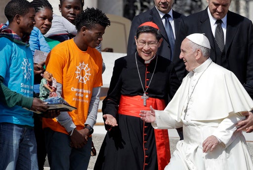 Francis greets Tagle, the then archbishop of Manila, and a group of migrants, during his weekly general audience at the Vatican, September 2017