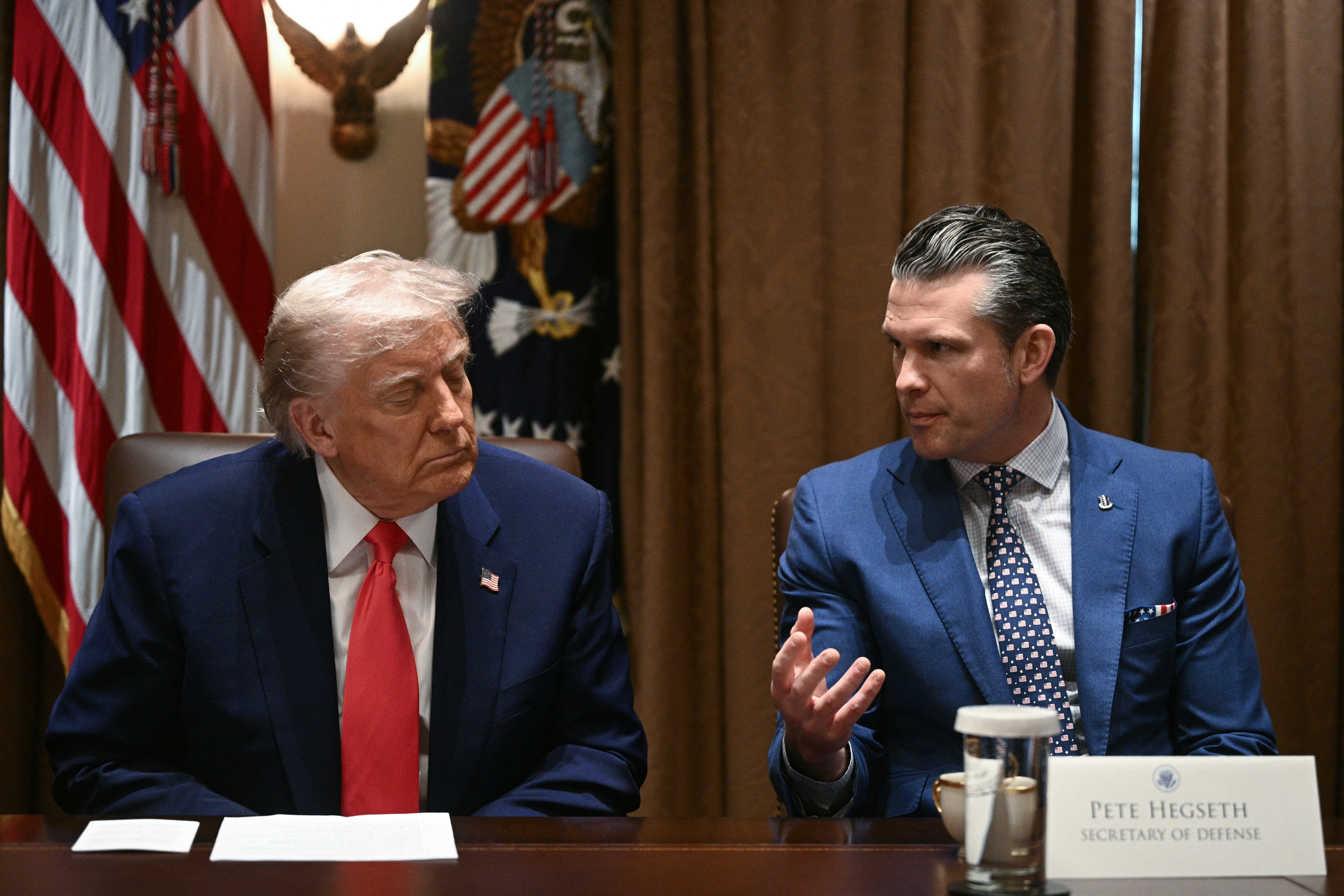 Donald Trump and Defense Secretary Pete Hegseth attend a cabinet meeting at the White House last month