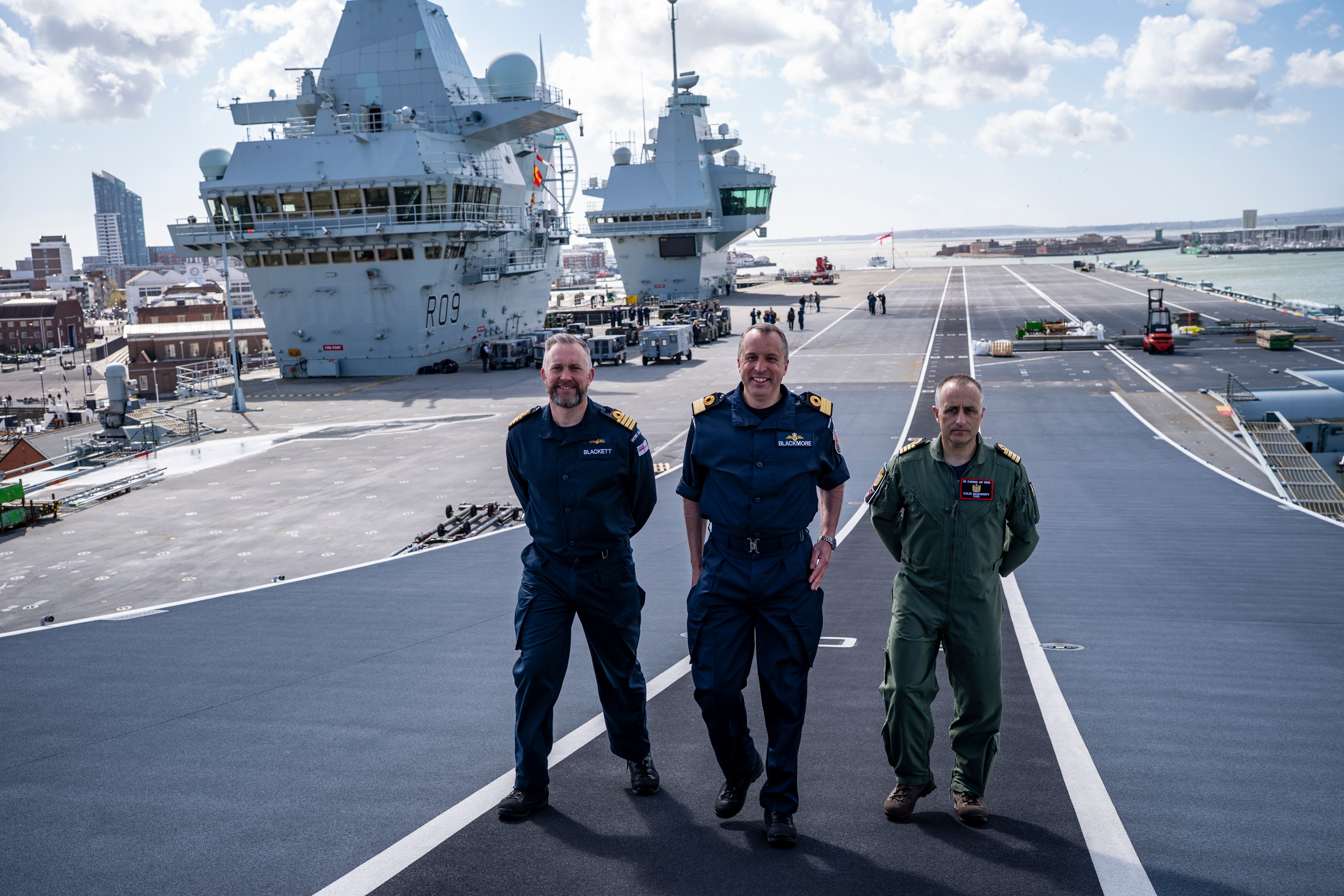 Captain Will Blackett RN, Commanding Officer of HMS Prince of Wales, left, Commodore James Blackmore RN, Commander Carrier Strike Group, centre, and Captain Colin McGannity RN, Commander Air Group, right, onboard HMS Prince of Wales docked at HM Naval Base Portsmouth, as they prepare the carrier ahead of it deploying as part of the UK Carrier Strike Group to conduct interoperability training and defence engagement in the Indo-Pacific. Picture date: Wednesday April 16, 2025