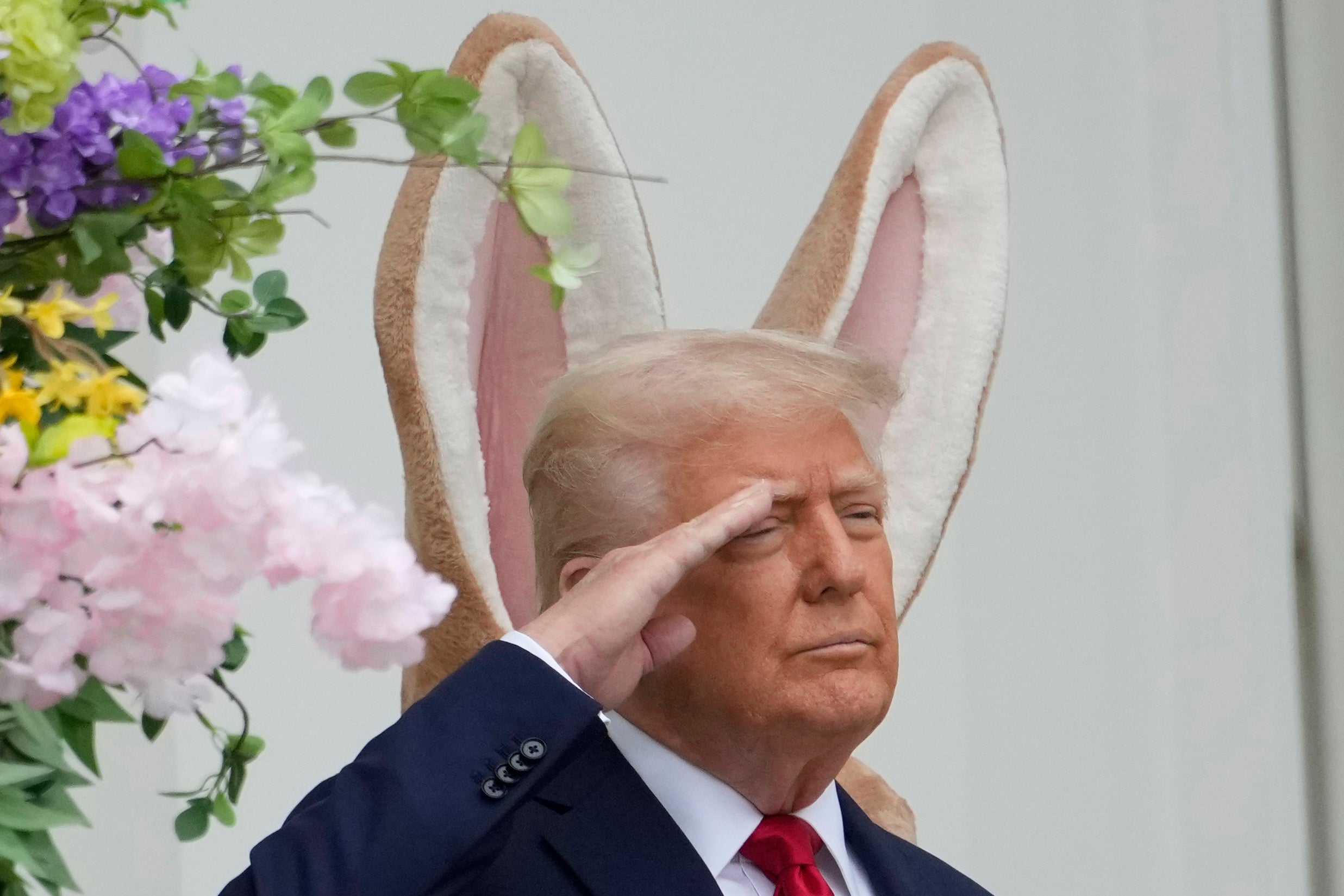 President Donald Trump arrived on the Blue Room Balcony alongside the Easter Bunny for the White House Egg Roll, saluting to the national anthem