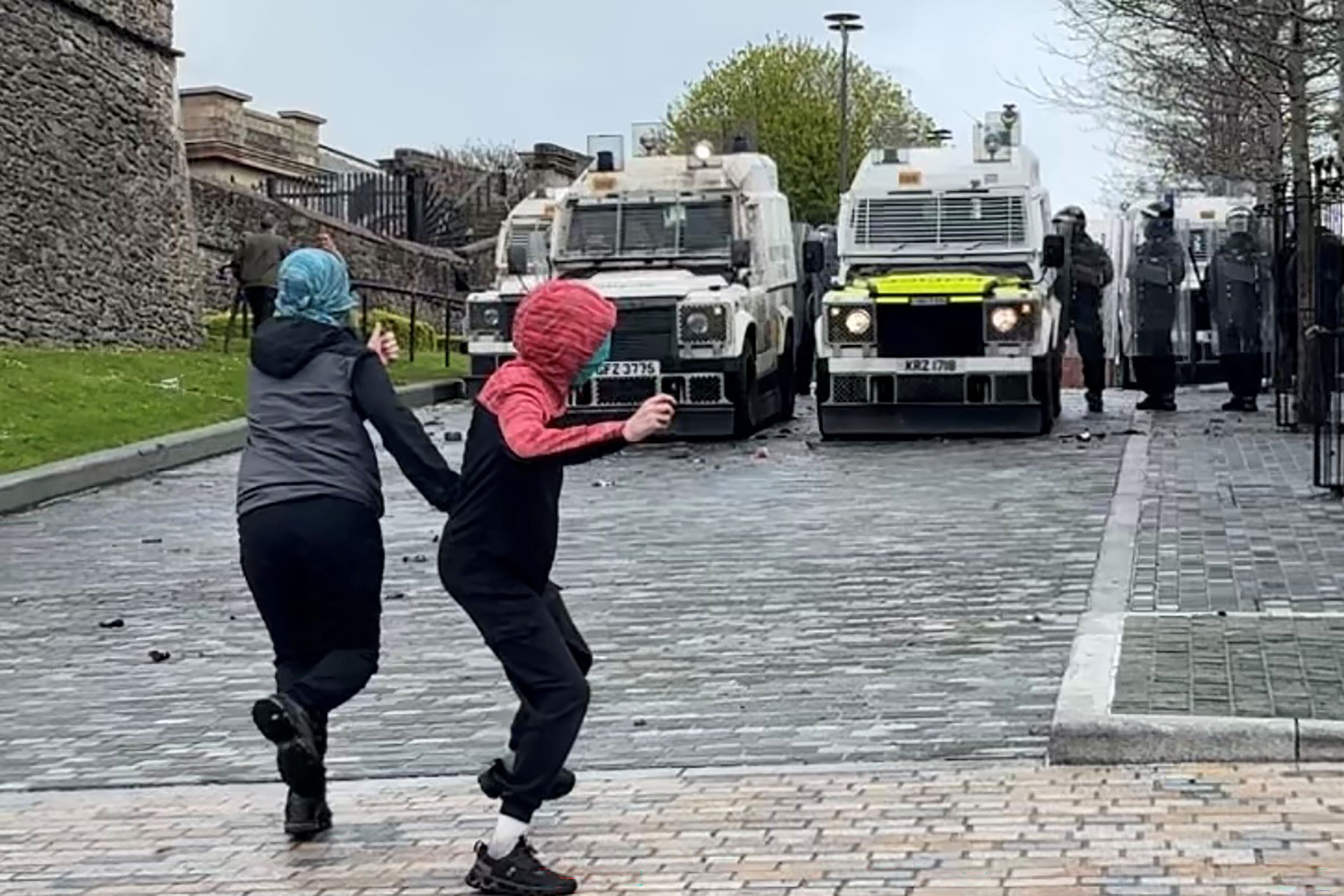Youths throwing rocks towards police in the Bogside area of Derry (Niall Carson/PA)