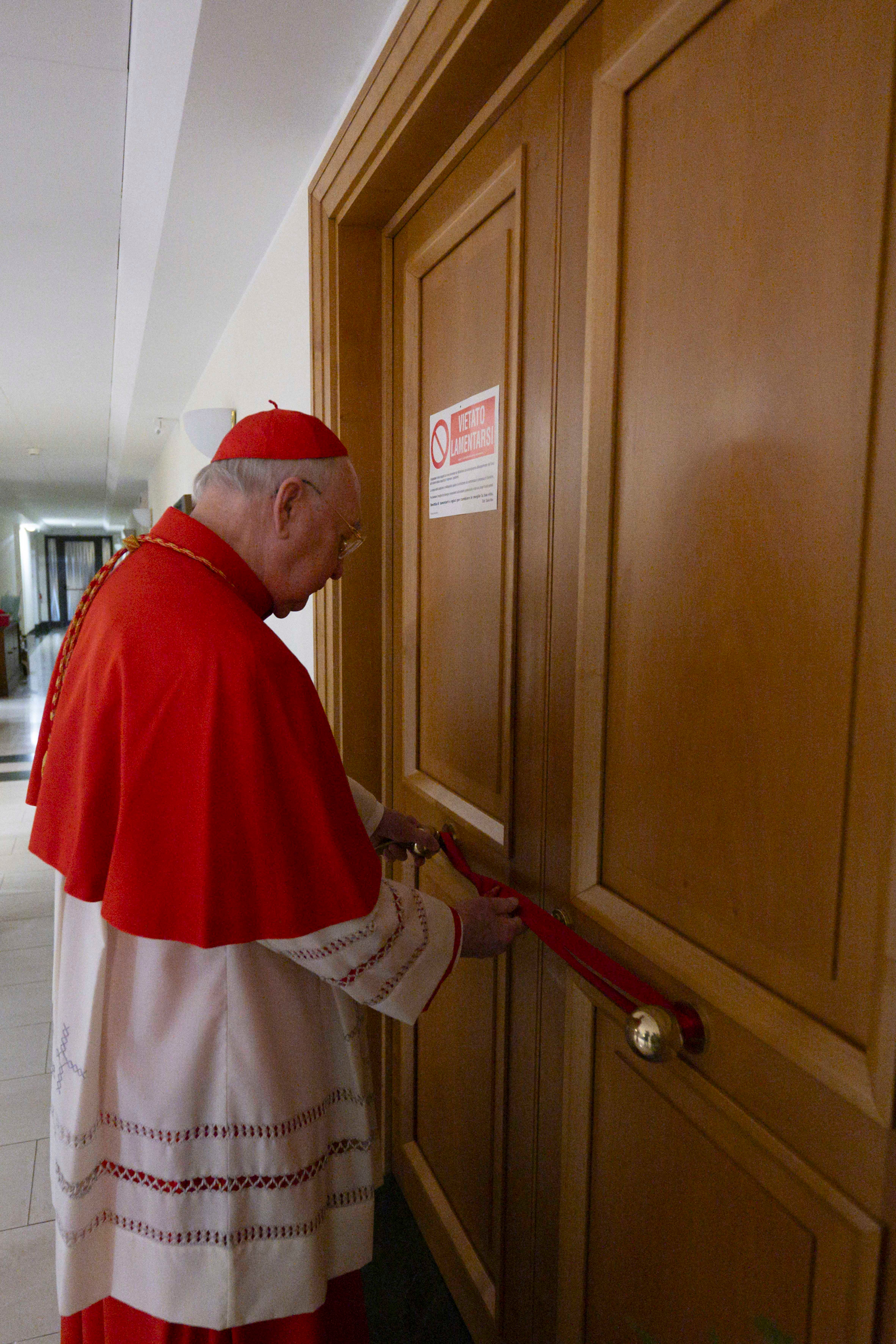 Cardinal Camerlengo Kevin Joseph Farrell sealing Pope Francis's private apartment