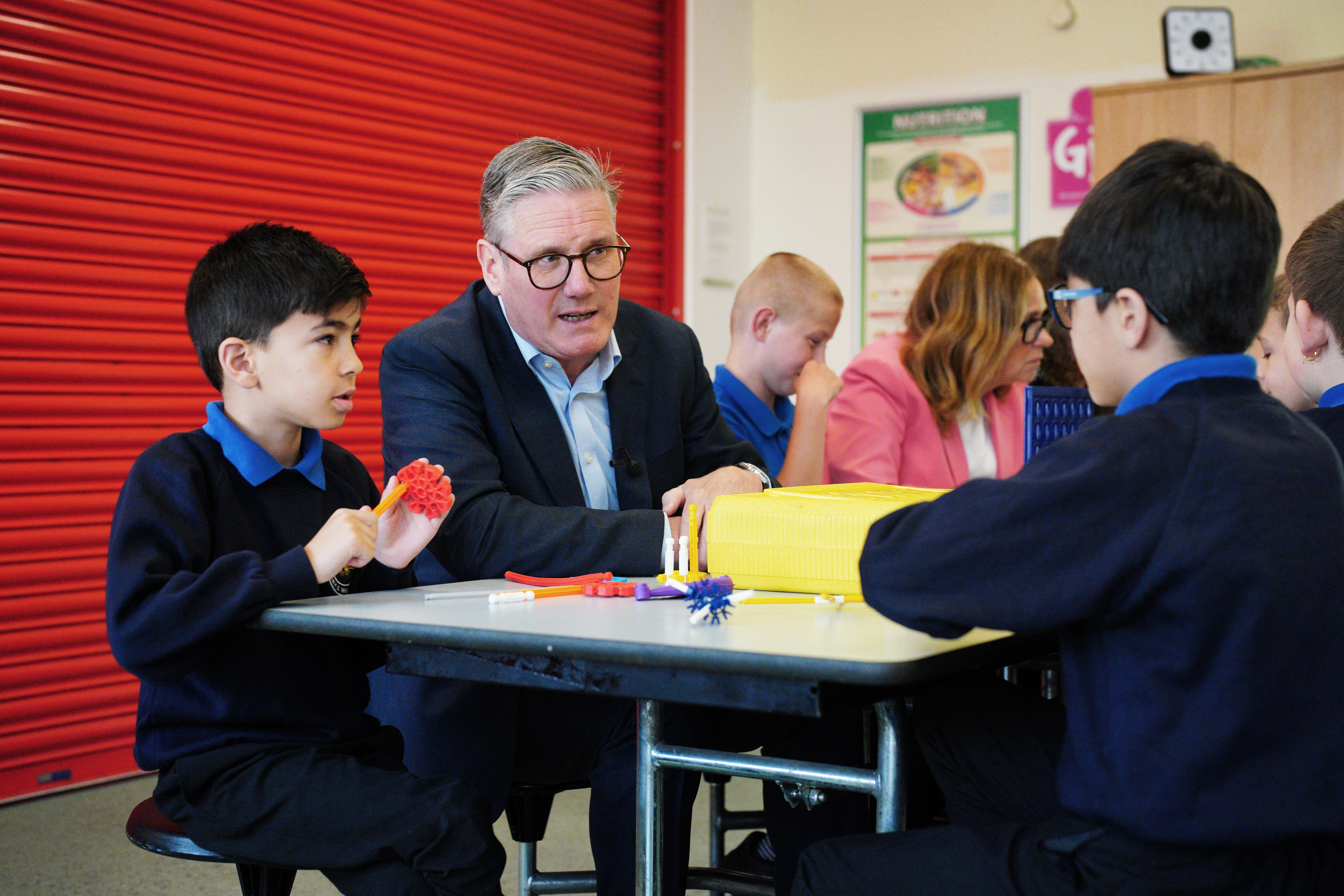 Prime Minister Sir Keir Starmer speaks to children during a visit to St Michael’s Junior School in Bath following the rollout of 750 new free breakfast clubs across England (Ben Birchall/PA)