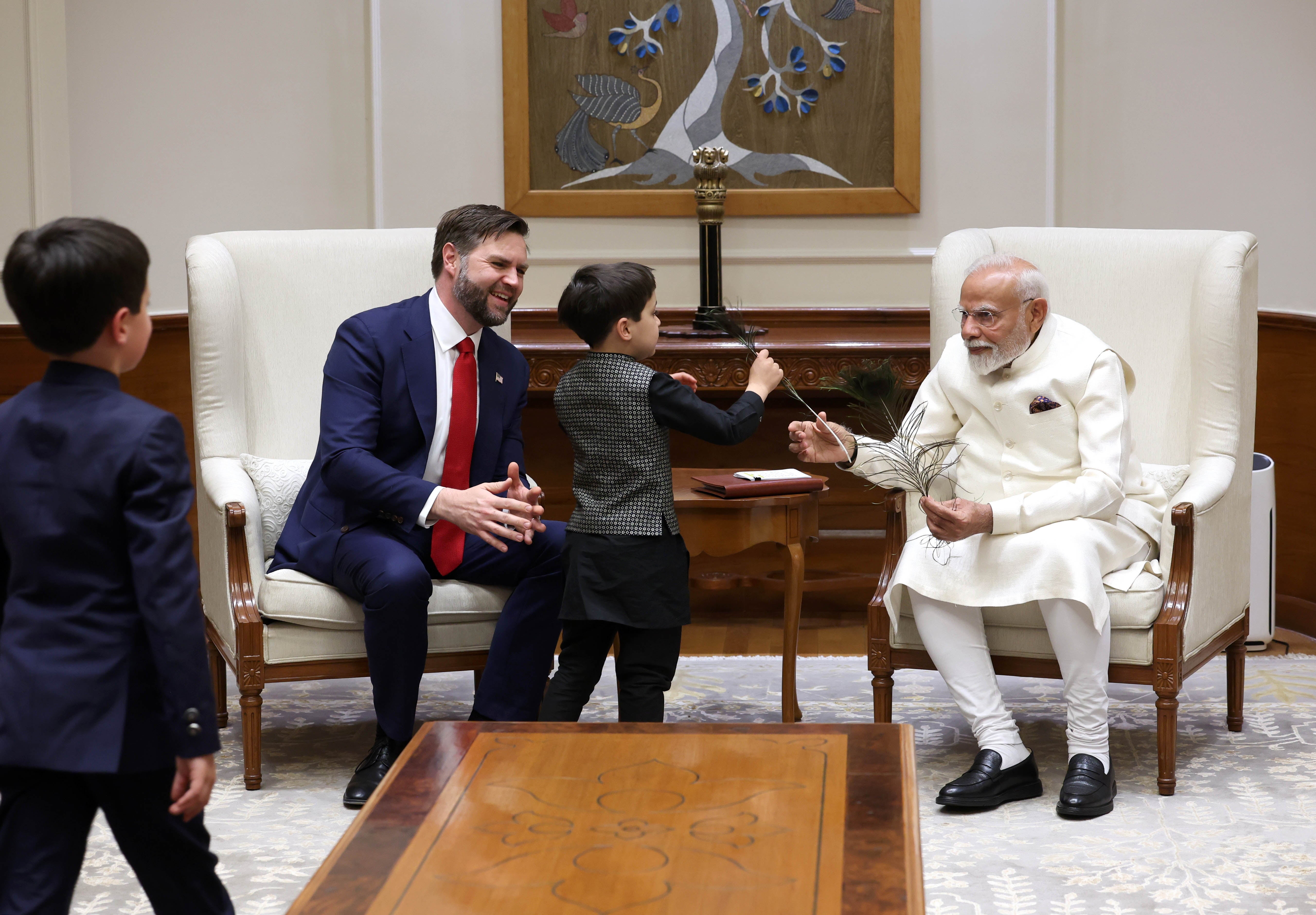 Narendra Modi giving a peacock feather to the Vance kids