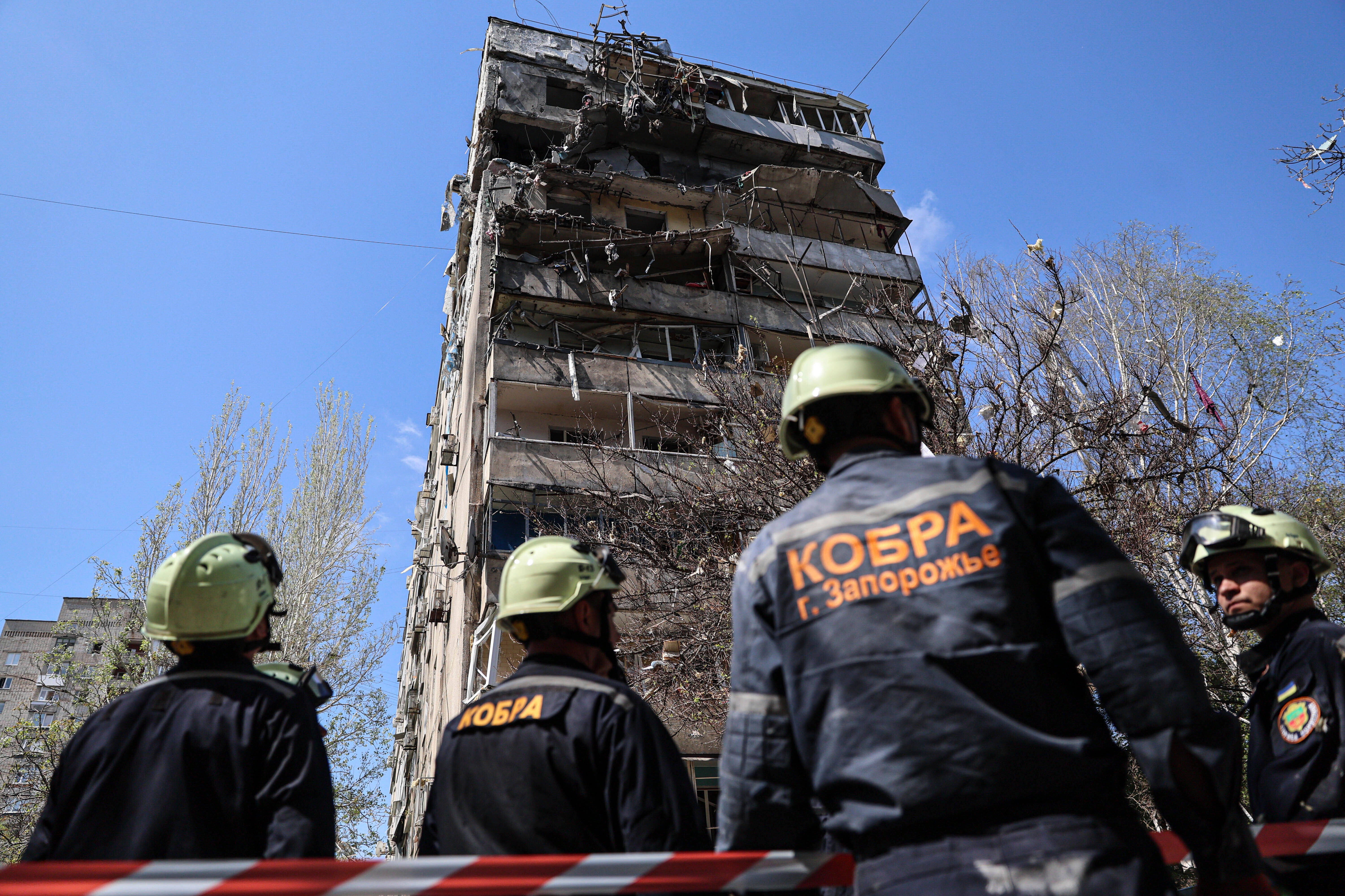 Rescue workers inspect a multistorey building damaged by a Russian strike on a residential neighbourhood in Zaporizhzhia, Ukraine, on 22 April