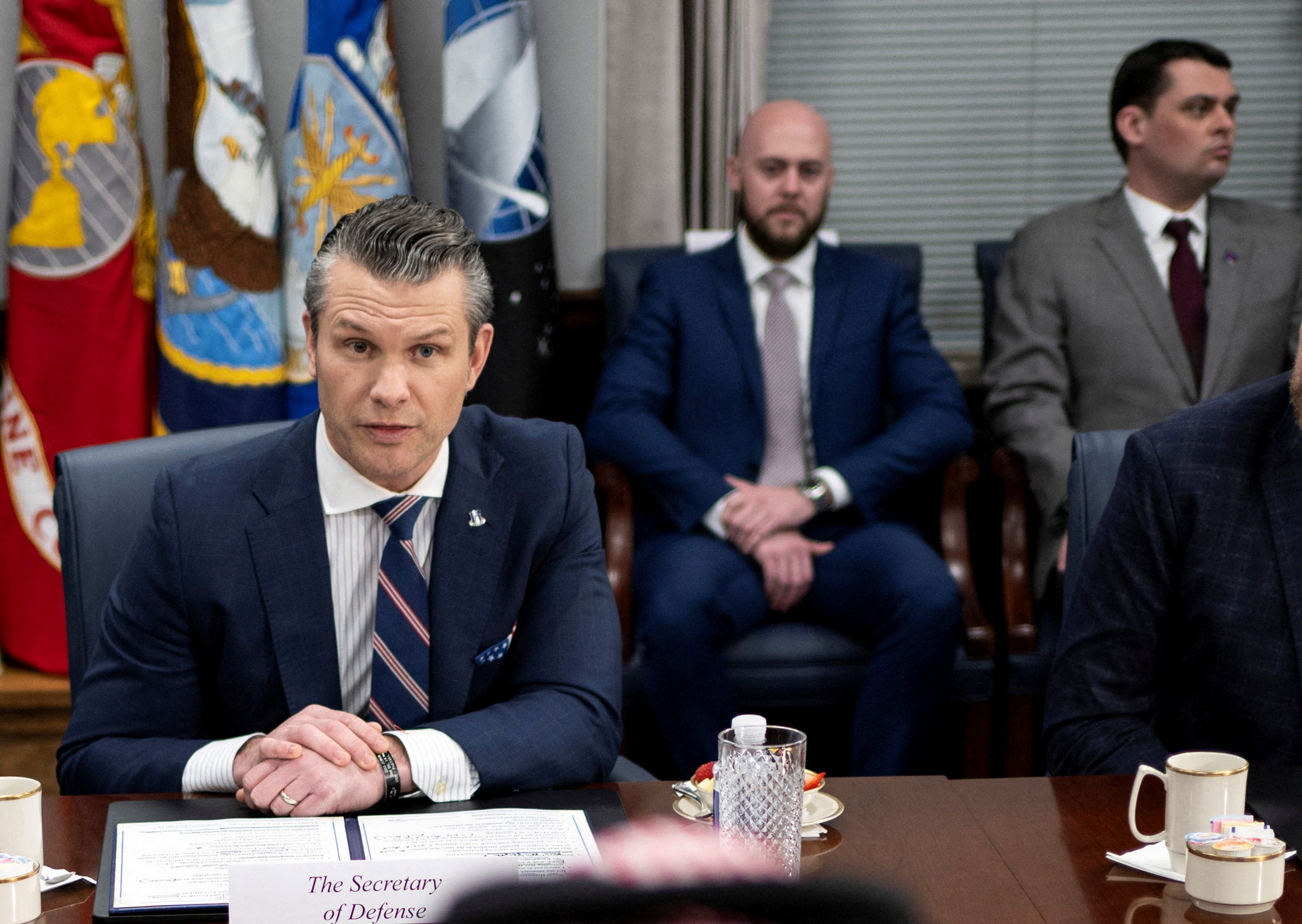 Pete Hegseth is flanked by members of his team, including senior adviser Dan Caldwell (back right), during a Pentagon meeting in February