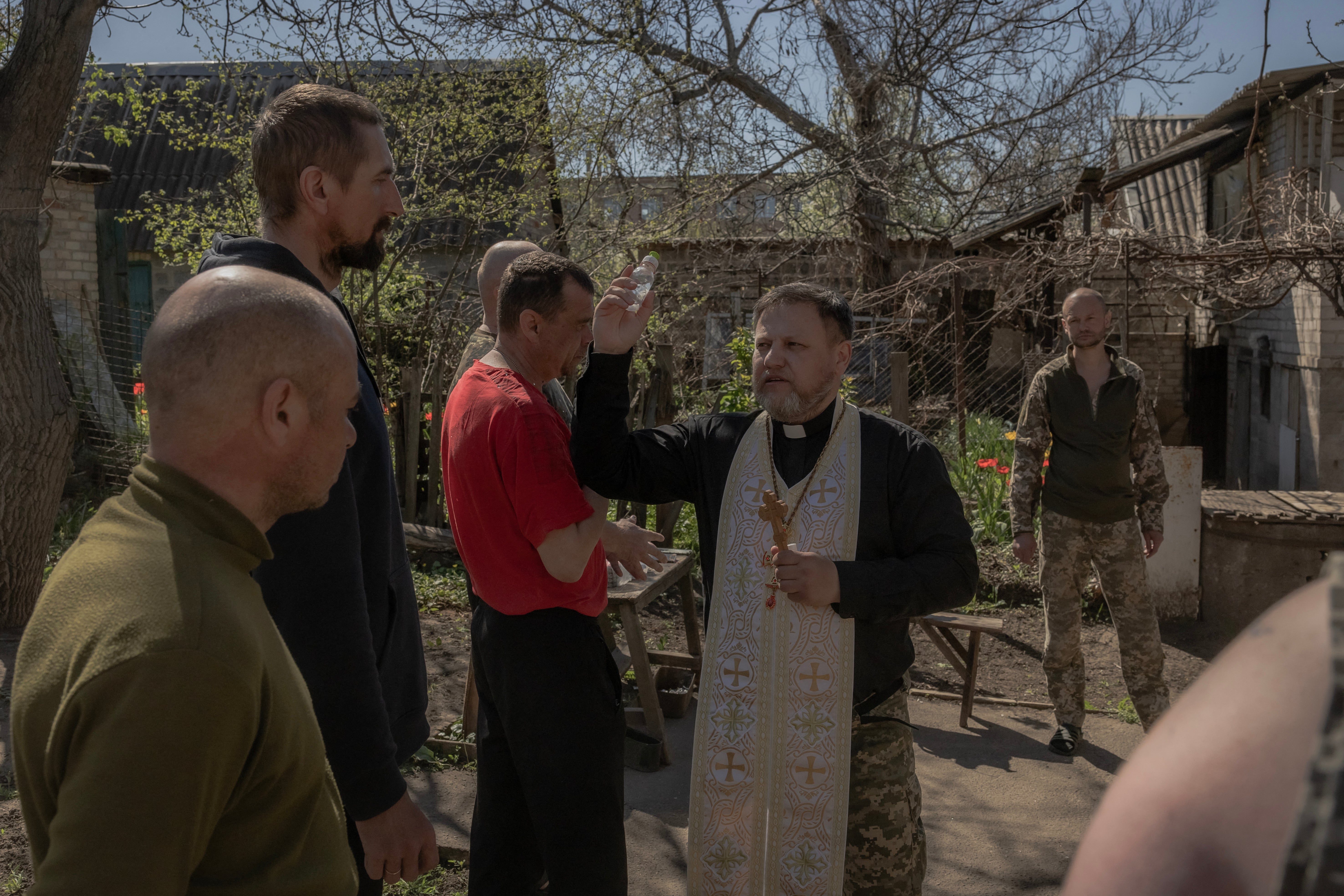 A military chaplain blesses Ukrainian servicemen of the 100th brigade and traditional cakes to celebrate Orthodox Easter, in the Donetsk region, on 20 April 2025