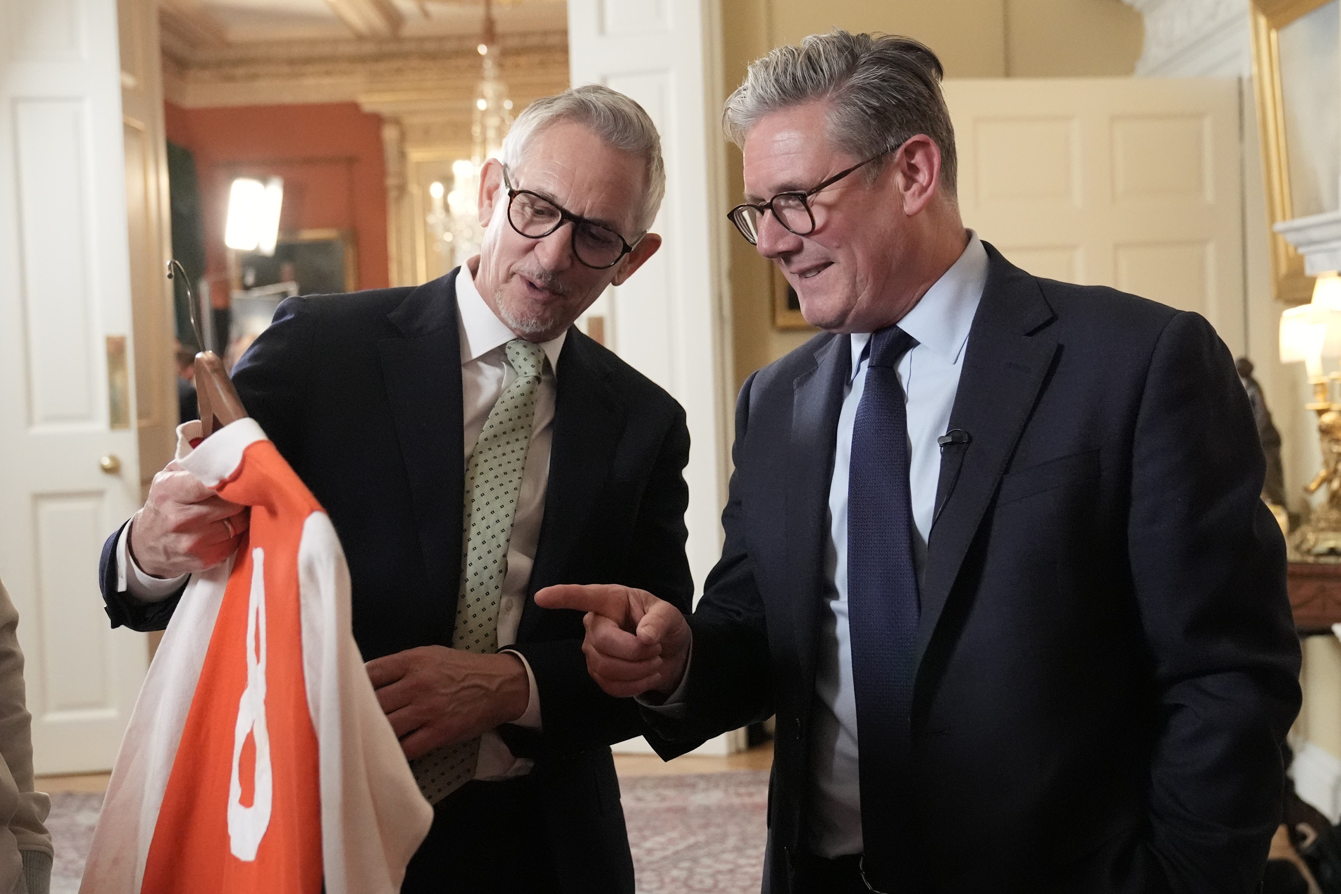 Prime Minister Sir Keir Starmer and Gary Lineker looking at a football shirt during a reception to celebrate St George’s Day at 10 Downing Street (Stefan Rousseau/PA)