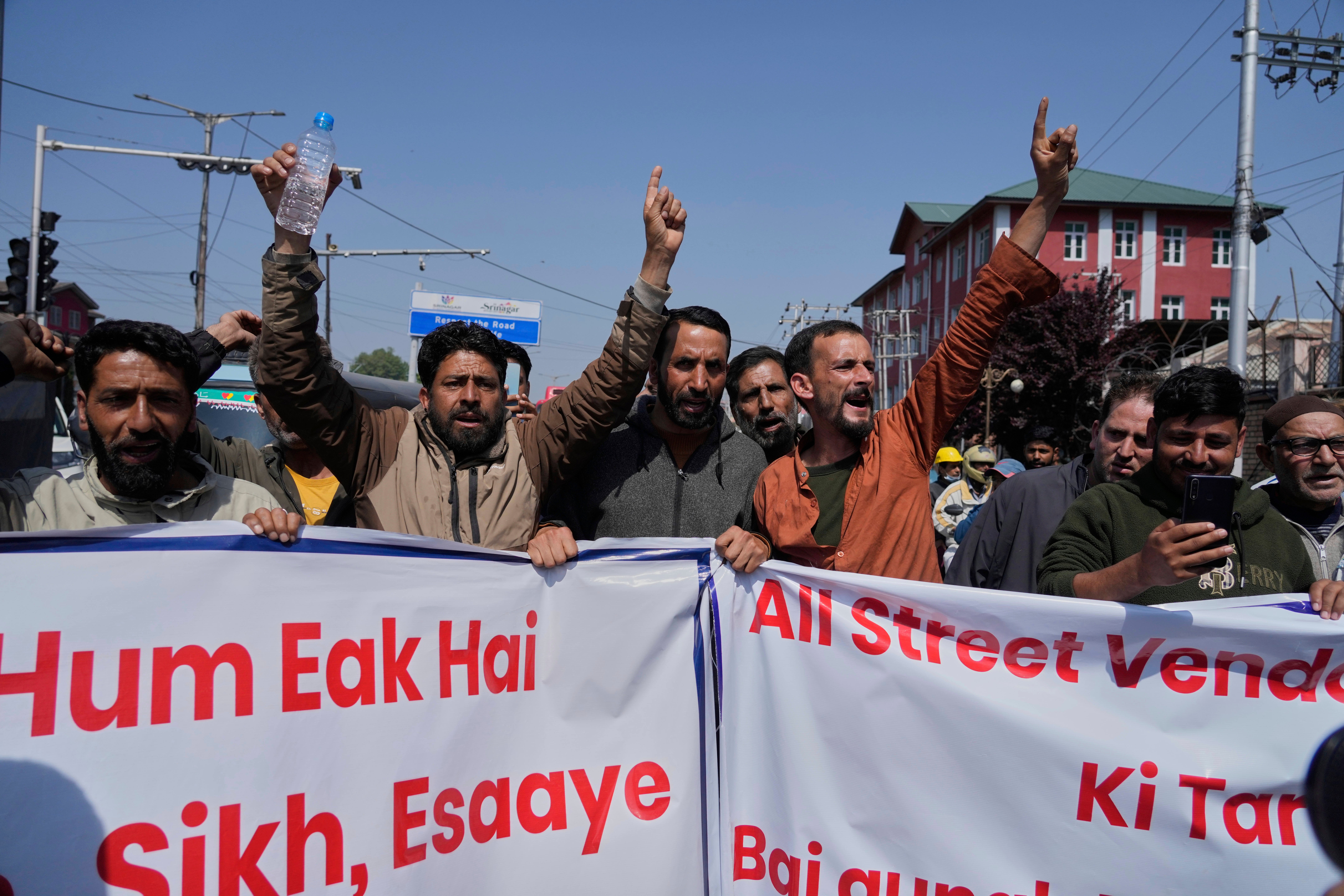 Kashmiri men shout slogans during a protest after tourists were killed in Srinagar, India