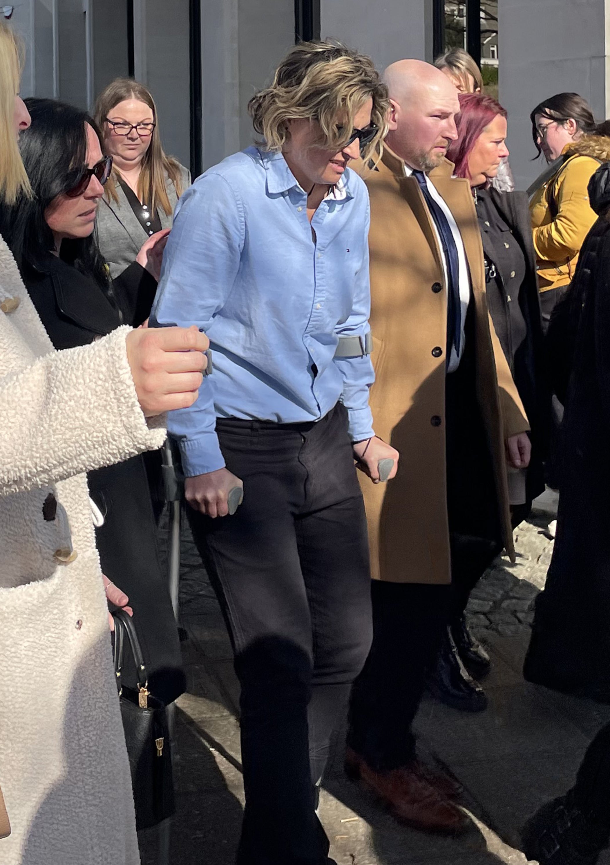 Nerys Lloyd (centre, on crutches) leaving Swansea Crown Court
