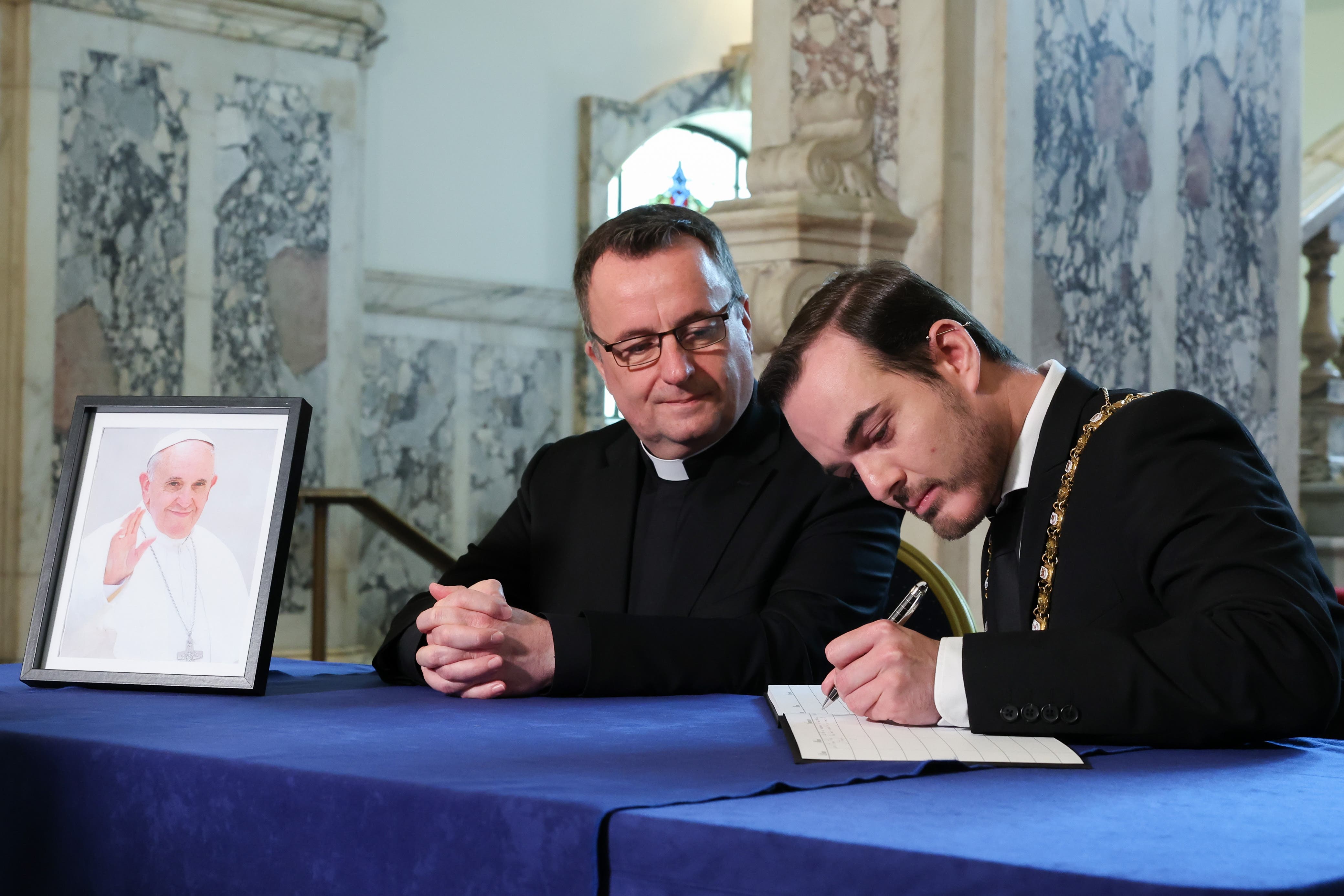 Belfast Lord Mayor Micky Murray (right) was joined at Belfast City Hall by Father Tim Bartlett, who helped to organise Francis’s visit to Ireland in 2018 (Belfast City Council/PA)